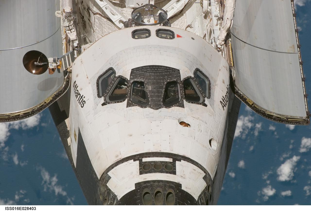 ISS016-E-028403 (9 Feb. 2008) --- An overhead view of the exterior of the Space Shuttle Atlantis' crew cabin, part of its payload bay doors and docking system was provided by Expedition 16 crewmembers.  Before docking with the International Space Station,  astronaut Steve Frick, STS-122 commander, flew the shuttle through a roll pitch maneuver or basically a backflip to allow the space station crew a good view of Atlantis' heat shield.  Using digital still cameras equipped with both 400  and 800 millimeter lenses, the ISS crewmembers took a number of photos of the shuttle's thermal protection system and sent them down to teams on the ground for analysis. A 400 millimeter lens was used for this image.