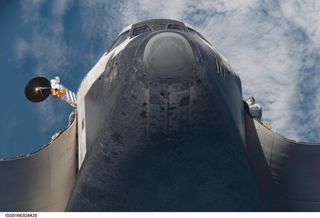 ISS016-E-028420 (9 Feb. 2008) ---   A low angle view of the nose and underside of the Space Shuttle Atlantis' crew cabin was provided by Expedition 16 crewmembers.  Before docking with the International Space Station,  astronaut Steve Frick, STS-122 commander, flew the shuttle through a roll pitch maneuver or basically a backflip to allow the space station crew a good view of Atlantis' heat shield.  Using digital still cameras equipped with both 400  and 800 millimeter lenses, the ISS crewmembers took a number of photos of the shuttle's thermal protection system and sent them down to teams on the ground for analysis. A 400 millimeter lens was used for this image.