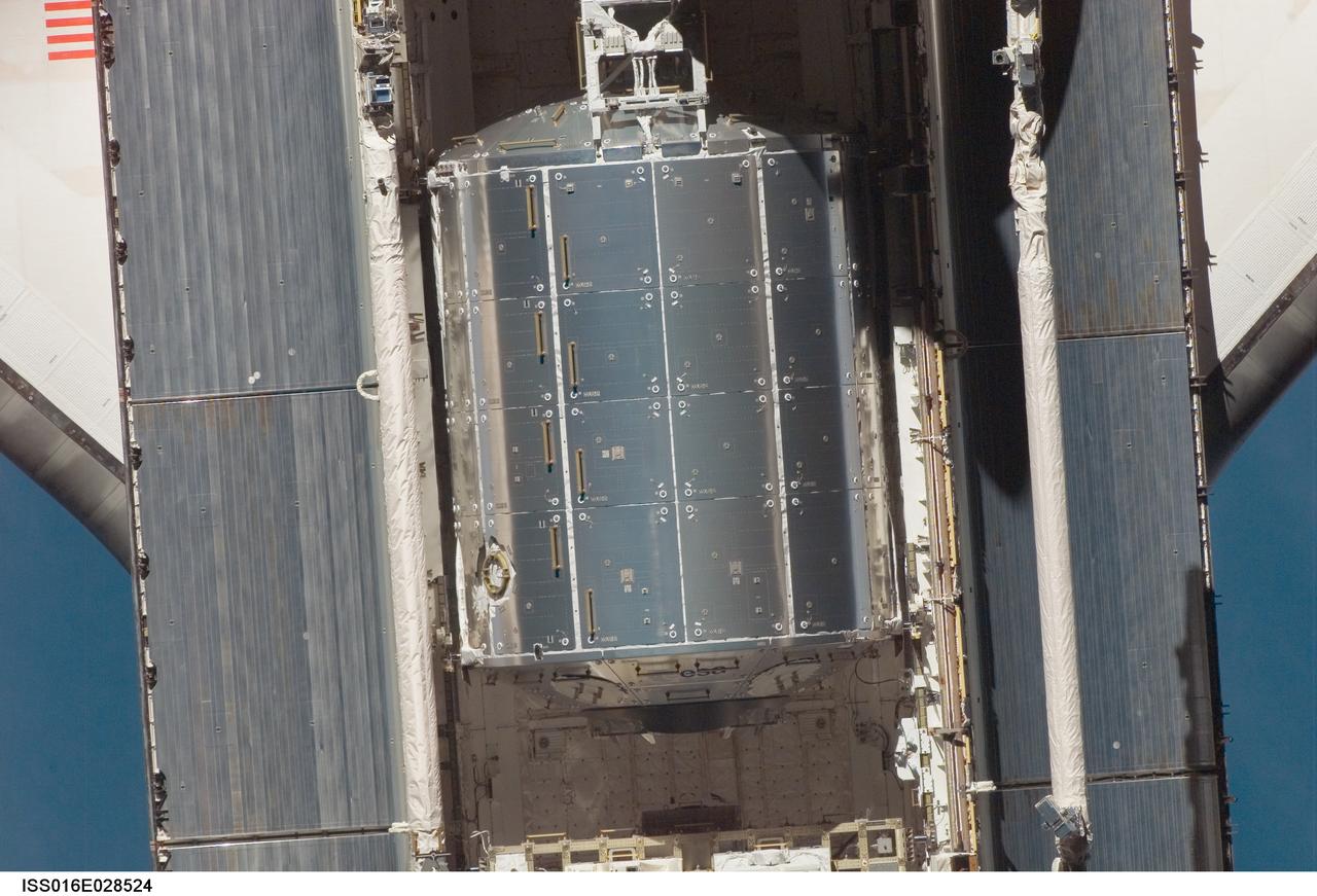 ISS016-E-028524 (9 Feb. 2008) --- An overhead view of the European Space Agency's Columbus laboratory in Space Shuttle Atlantis' cargo bay was provided by Expedition 16 crewmembers.  Before docking with the International Space Station,  astronaut Steve Frick, STS-122 commander, flew the shuttle through a roll pitch maneuver or basically a backflip to allow the space station crew a good view of Atlantis' heat shield.  Using digital still cameras equipped with both 400  and 800 millimeter lenses, the ISS crewmembers took a number of photos of the shuttle's thermal protection system and sent them down to teams on the ground for analysis. A 400 millimeter lens was used for this image.