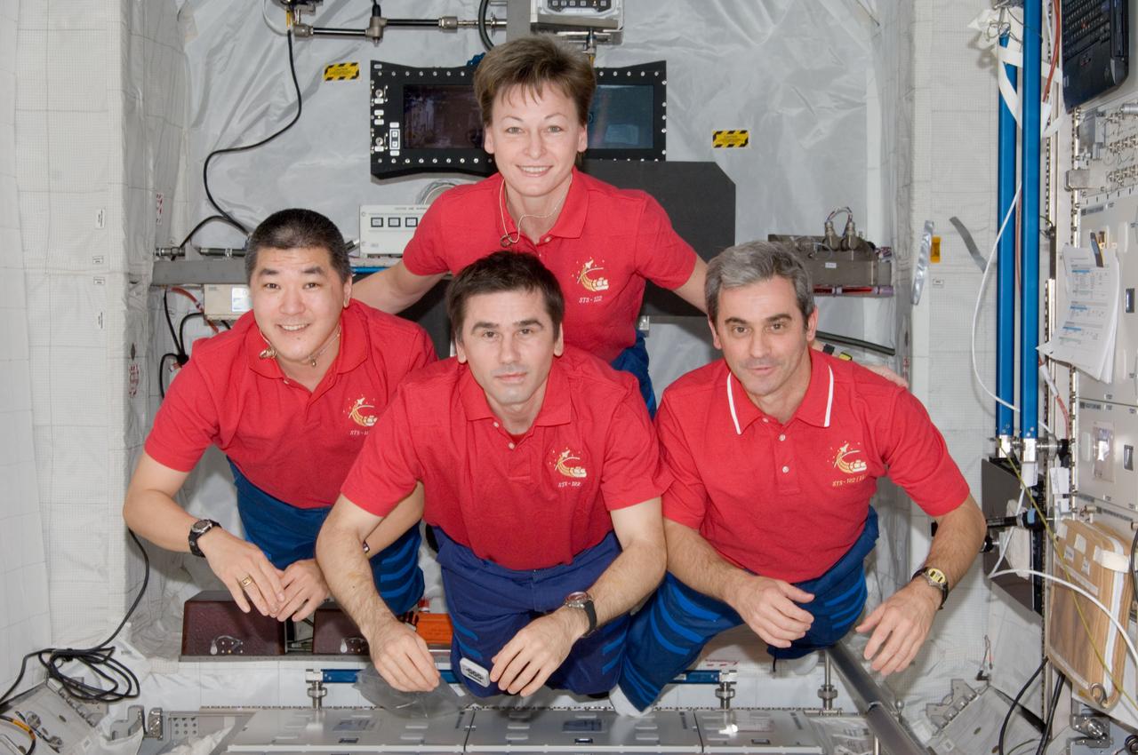 ISS016-E-029889 (16 Feb. 2008) --- NASA astronauts Peggy Whitson, Expedition 16 commander; Daniel Tani (left), STS-122 mission specialist; Russian Federal Space Agency cosmonaut Yuri Malenchenko and European Space Agency (ESA) astronaut Leopold Eyharts, both Expedition 16 flight engineers, pose for a photo following a joint news conference in the Columbus laboratory of the International Space Station while Space Shuttle Atlantis is docked with the station. Tani, who joined the station's Expedition 16 crew in October, is being replaced by Eyharts, who arrived at the station with the STS-122 crew.