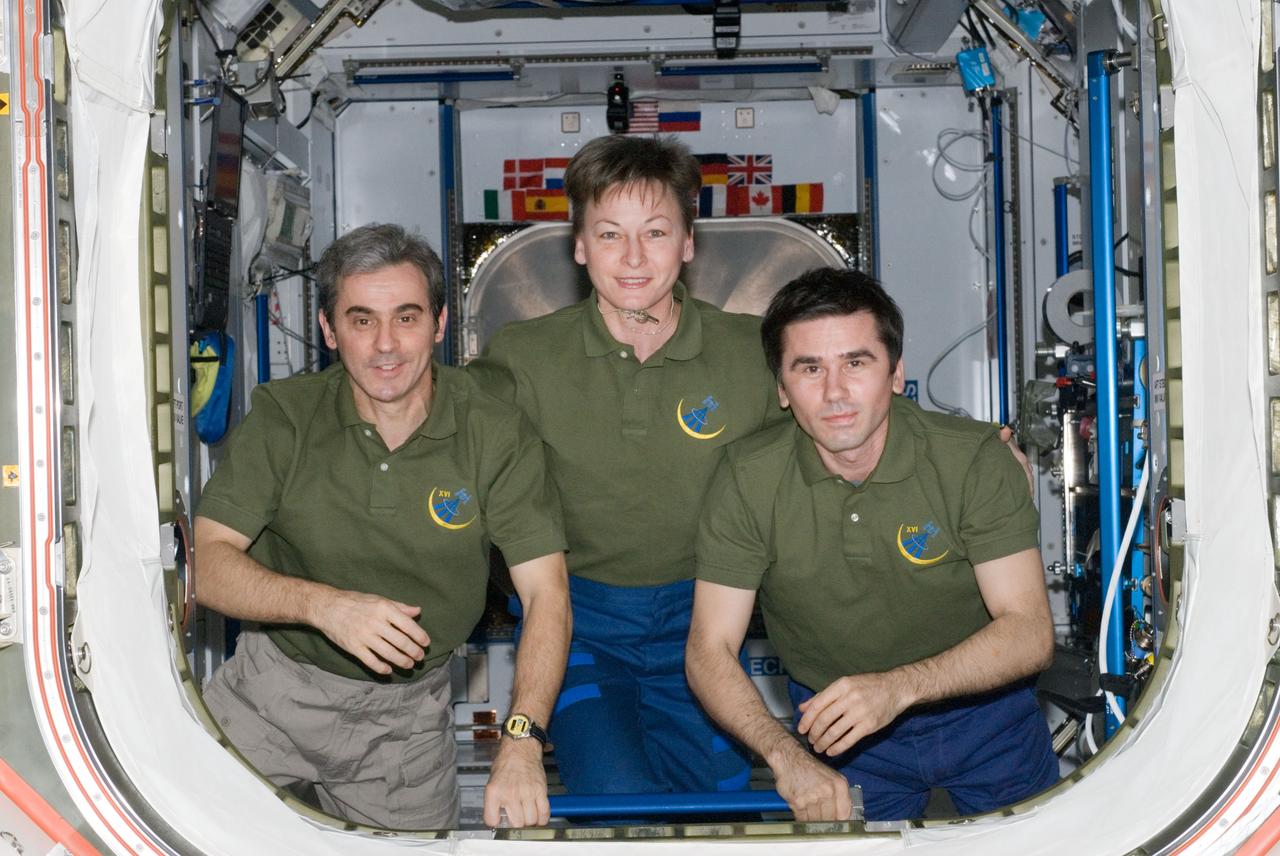 ISS016-E-031769 (10 March 2008) --- NASA astronaut Peggy Whitson (center), Expedition 16 commander; European Space Agency (ESA) astronaut Leopold Eyharts (left) and Russian Federal Space Agency cosmonaut Yuri Malenchenko, both flight engineers, pose for a photo in the hatchway between the Harmony node and Destiny laboratory of the International Space Station.
