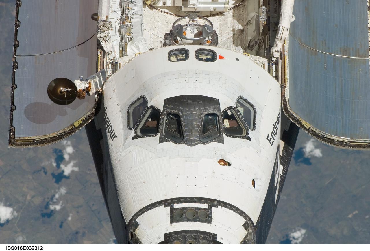 ISS016-E-032312 (12 March 2008) --- An overhead view of the exterior of Space Shuttle Endeavour's crew cabin, part of its payload bay doors and docking system was provided by Expedition 16 crewmembers on the International Space Station (ISS). Before docking with the station, astronaut Dominic Gorie, STS-123 commander, flew the shuttle through a roll pitch maneuver or basically a backflip to allow the space station crew a good view of Endeavour's heat shield. Using digital still cameras equipped with both 400 and 800 millimeter lenses, the ISS crewmembers took a number of photos of the shuttle's thermal protection system and sent them down to teams on the ground for analysis. A 400 millimeter lens was used for this image.
