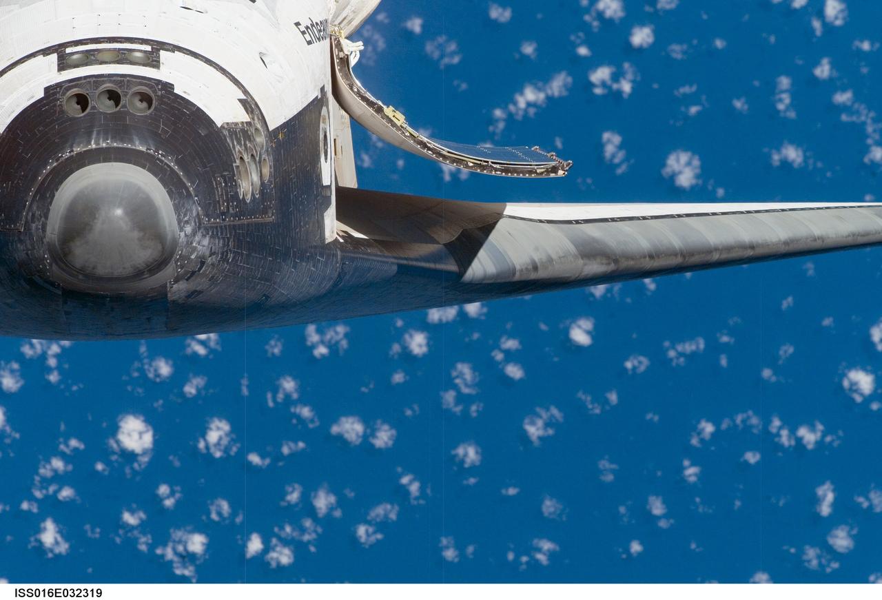 ISS016-E-032319 (12 March 2008) --- A close-up view of the exterior of Space Shuttle Endeavour's nose, port wing and payload bay door was provided by Expedition 16 crewmembers on the International Space Station (ISS). Before docking with the station, astronaut Dominic Gorie, STS-123 commander, flew the shuttle through a roll pitch maneuver or basically a backflip to allow the space station crew a good view of Endeavour's heat shield. Using digital still cameras equipped with both 400 and 800 millimeter lenses, the ISS crewmembers took a number of photos of the shuttle's thermal protection system and sent them down to teams on the ground for analysis. A 400 millimeter lens was used for this image.