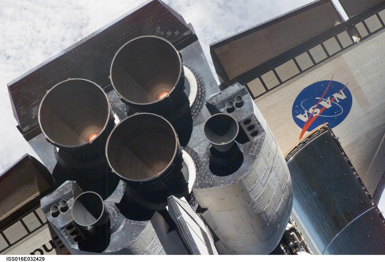 ISS016-E-032429 (12 March 2008) --- A close-up view of Space Shuttle Endeavour's tail section was provided by Expedition 16 crewmembers on the International Space Station (ISS). The image provides partial views of the shuttle's main engines, orbital maneuvering system (OMS) pods, a portion of the payload bay door panels and the shuttle's wings. Before docking with the station, astronaut Dominic Gorie, STS-123 commander, flew the shuttle through a roll pitch maneuver or basically a backflip to allow the space station crew a good view of Endeavour's heat shield. Using digital still cameras equipped with both 400 and 800 millimeter lenses, the ISS crewmembers took a number of photos of the shuttle's thermal protection system and sent them down to teams on the ground for analysis. A 400 millimeter lens was used for this image.