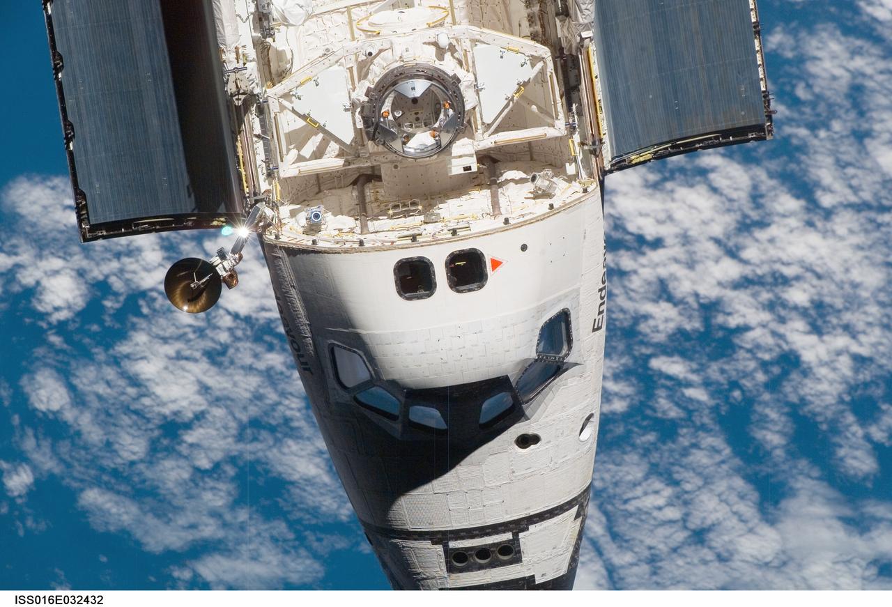 ISS016-E-032432 (12 March 2008) --- An overhead view of the exterior of Space Shuttle Endeavour's crew cabin, part of its payload bay doors and docking system was provided by Expedition 16 crewmembers on the International Space Station (ISS). Before docking with the station, astronaut Dominic Gorie, STS-123 commander, flew the shuttle through a roll pitch maneuver or basically a backflip to allow the space station crew a good view of Endeavour's heat shield. Using digital still cameras equipped with both 400 and 800 millimeter lenses, the ISS crewmembers took a number of photos of the shuttle's thermal protection system and sent them down to teams on the ground for analysis. A 400 millimeter lens was used for this image.