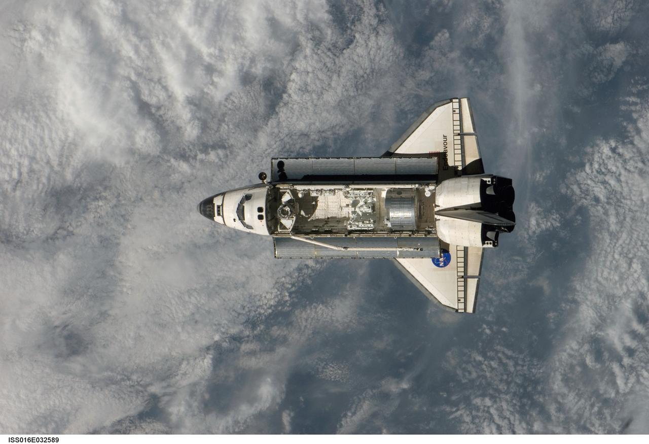 ISS016-E-032589 (12 March 2008) --- Backdropped by a cloud-covered part of Earth, Space Shuttle Endeavour approaches the International Space Station during STS-123 rendezvous and docking operations. Docking occurred at 10:49 p.m. (CDT) on March 12, 2008. The Canadian-built Dextre robotic system and the logistics module for the Japanese Kibo laboratory are visible in Endeavour's cargo bay.