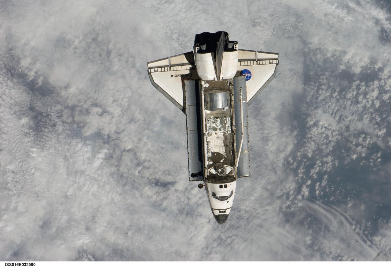 ISS016-E-032590 (12 March 2008) --- Backdropped by a cloud-covered part of Earth, Space Shuttle Endeavour approaches the International Space Station during STS-123 rendezvous and docking operations. Docking occurred at 10:49 p.m. (CDT) on March 12, 2008. The Canadian-built Dextre robotic system and the logistics module for the Japanese Kibo laboratory are visible in Endeavour's cargo bay.