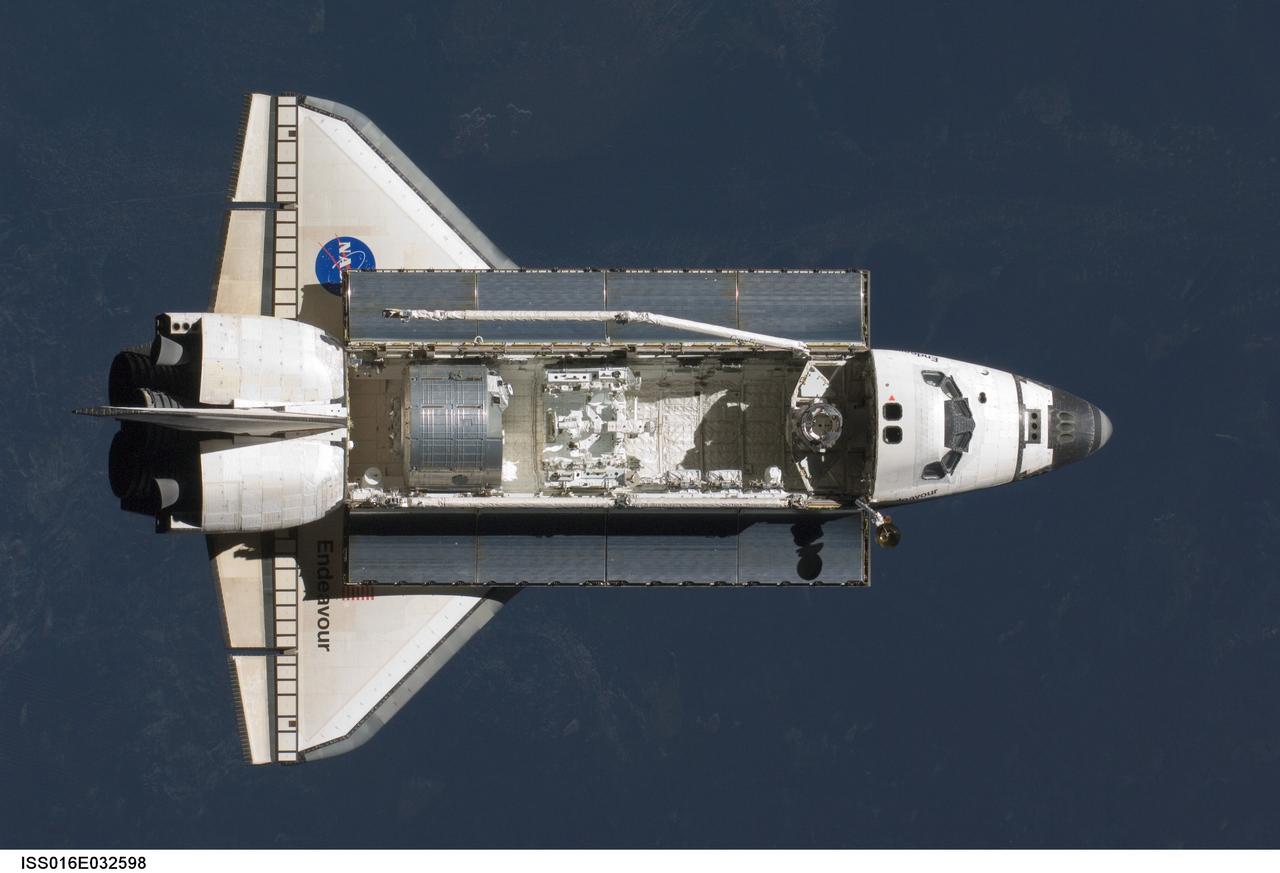 ISS016-E-032598 (12 March 2008) --- Space Shuttle Endeavour approaches the International Space Station during STS-123 rendezvous and docking operations. Docking occurred at 10:49 p.m. (CDT) on March 12, 2008. The Canadian-built Dextre robotic system and the logistics module for the Japanese Kibo laboratory are visible in Endeavour's cargo bay.