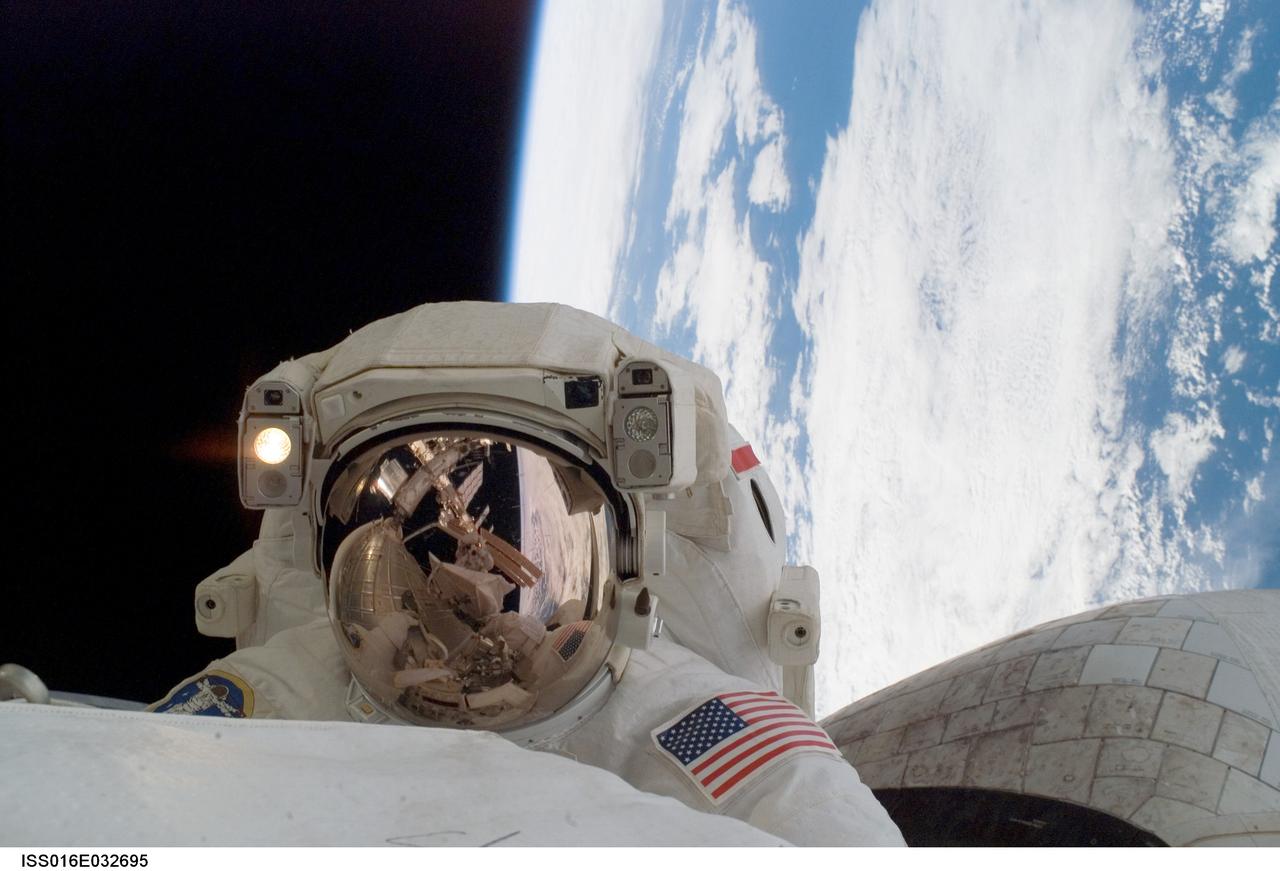 ISS016-E-032695 (13/14 March 2008) --- Astronaut Rick Linnehan, STS-123 mission specialist, participates in the mission's first scheduled session of extravehicular activity (EVA) as construction and maintenance continue on the International Space Station. During the seven-hour and one-minute spacewalk, Linnehan and astronaut Garrett Reisman (out of frame), Expedition 16 flight engineer, prepared the Japanese logistics module-pressurized section (JLP) for removal from Space Shuttle Endeavour's payload bay; opened the Centerline Berthing Camera System on top of the Harmony module; removed the Passive Common Berthing Mechanism and installed both the Orbital Replacement Unit (ORU) tool change out mechanisms on the Canadian-built Dextre robotic system, the final element of the station's Mobile Servicing System.