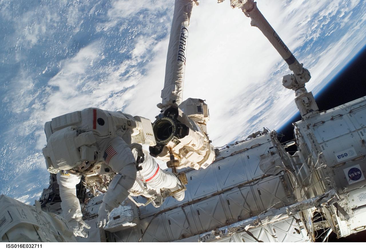 ISS016-E-032711 (13/14 March 2008) --- Anchored to a Canadarm2 mobile foot restraint, astronaut Rick Linnehan, STS-123 mission specialist, participates in the mission's first scheduled session of extravehicular activity (EVA) as construction and maintenance continue on the International Space Station. During the seven-hour and one-minute spacewalk, Linnehan and astronaut Garrett Reisman (out of frame), Expedition 16 flight engineer, prepared the Japanese logistics module-pressurized section (JLP) for removal from Space Shuttle Endeavour's payload bay; opened the Centerline Berthing Camera System on top of the Harmony module; removed the Passive Common Berthing Mechanism and installed both the Orbital Replacement Unit (ORU) tool change out mechanisms on the Canadian-built Dextre robotic system, the final element of the station's Mobile Servicing System.