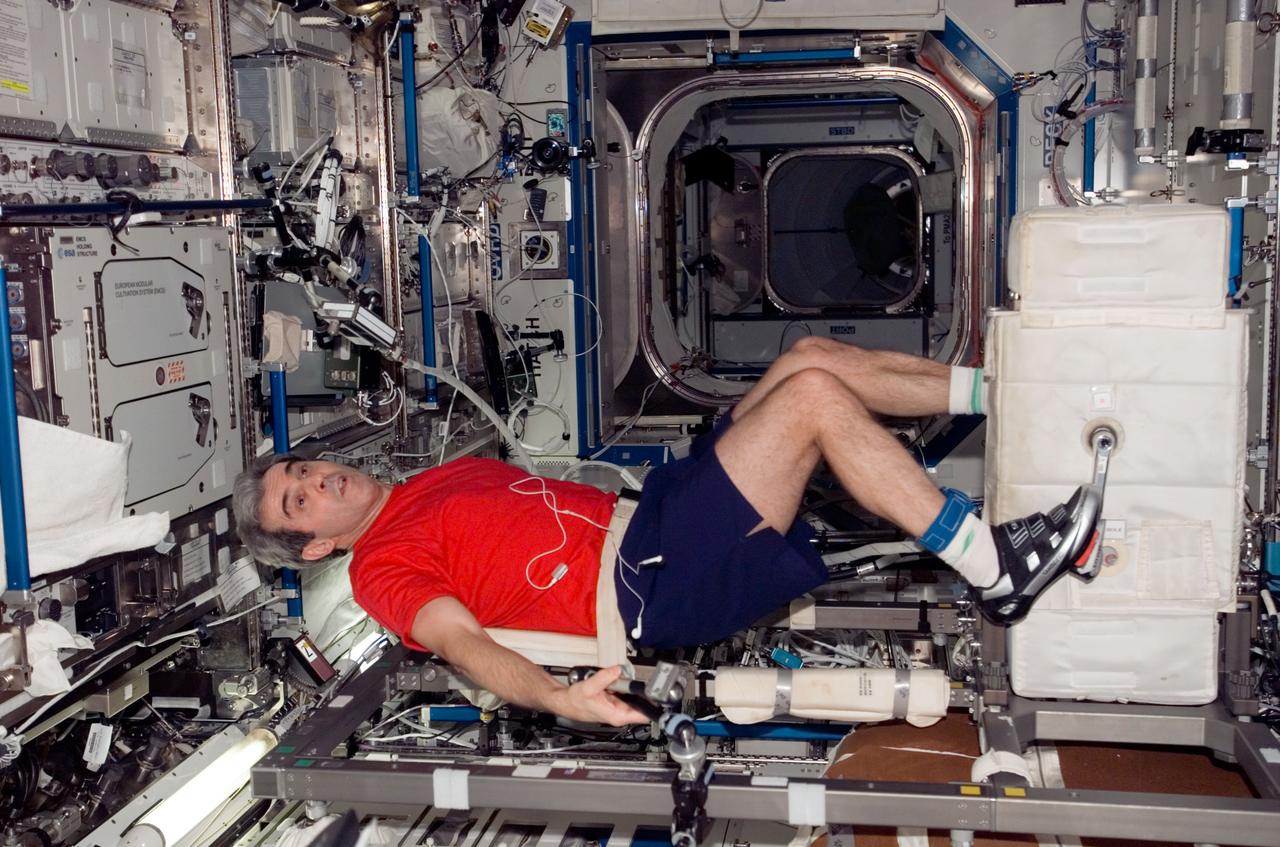 ISS016-E-032805 (16 March 2008) --- European Space Agency (ESA) astronaut Leopold Eyharts, Expedition 16 flight engineer, exercises on the Cycle Ergometer with Vibration Isolation System (CEVIS) in the Destiny laboratory of the International Space Station while Space Shuttle Endeavour (STS-123) remains docked with the station.