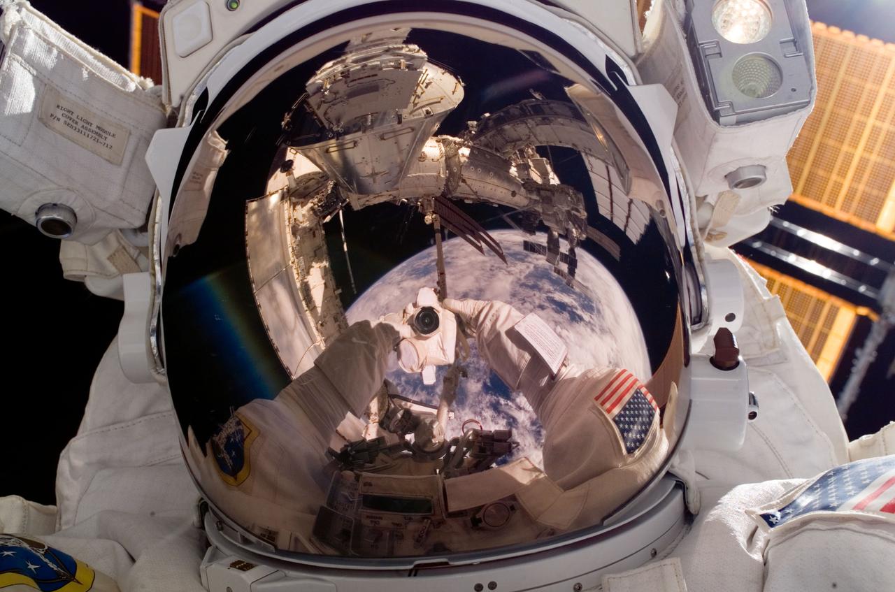 ISS016-E-033024 (17/18 March 2008) --- Astronaut Rick Linnehan, STS-123 mission specialist, uses a digital camera to expose a photo of his helmet visor during the mission's third scheduled session of extravehicular activity (EVA) as construction and maintenance continue on the International Space Station. Also visible in the reflections in the visor are various components of the station, the docked Space Shuttle Endeavour and a blue and white portion of Earth. During the 6-hour, 53-minute spacewalk, Linnehan and astronaut Robert L. Behnken (out of frame), mission specialist, installed a spare-parts platform and tool-handling assembly for Dextre, also known as the Special Purpose Dextrous Manipulator (SPDM). Among other tasks, they also checked out and calibrated Dextre's end effector and attached critical spare parts to an external stowage platform. The new robotic system is scheduled to be activated on a power and data grapple fixture located on the Destiny laboratory on flight day nine.