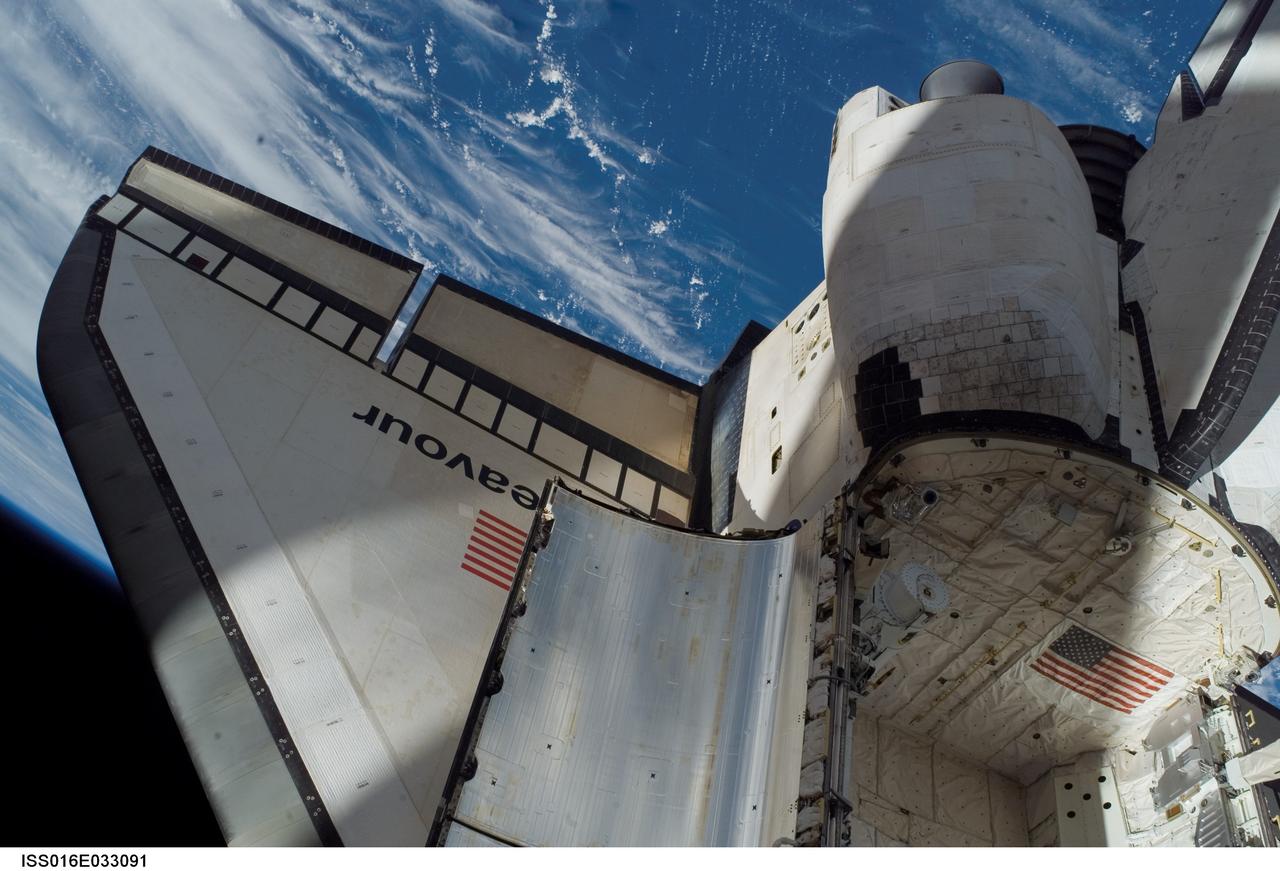ISS016-E-033091 (18 March 2008) --- Backdropped by a blue and white section of Earth and the blackness of space, Space Shuttle Endeavour's starboard wing, a portion of its payload bay and part of its orbital maneuvering system (OMS) pods are featured in this image photographed by a crewmember during the STS-123 mission's third planned session of extravehicular activity (EVA).