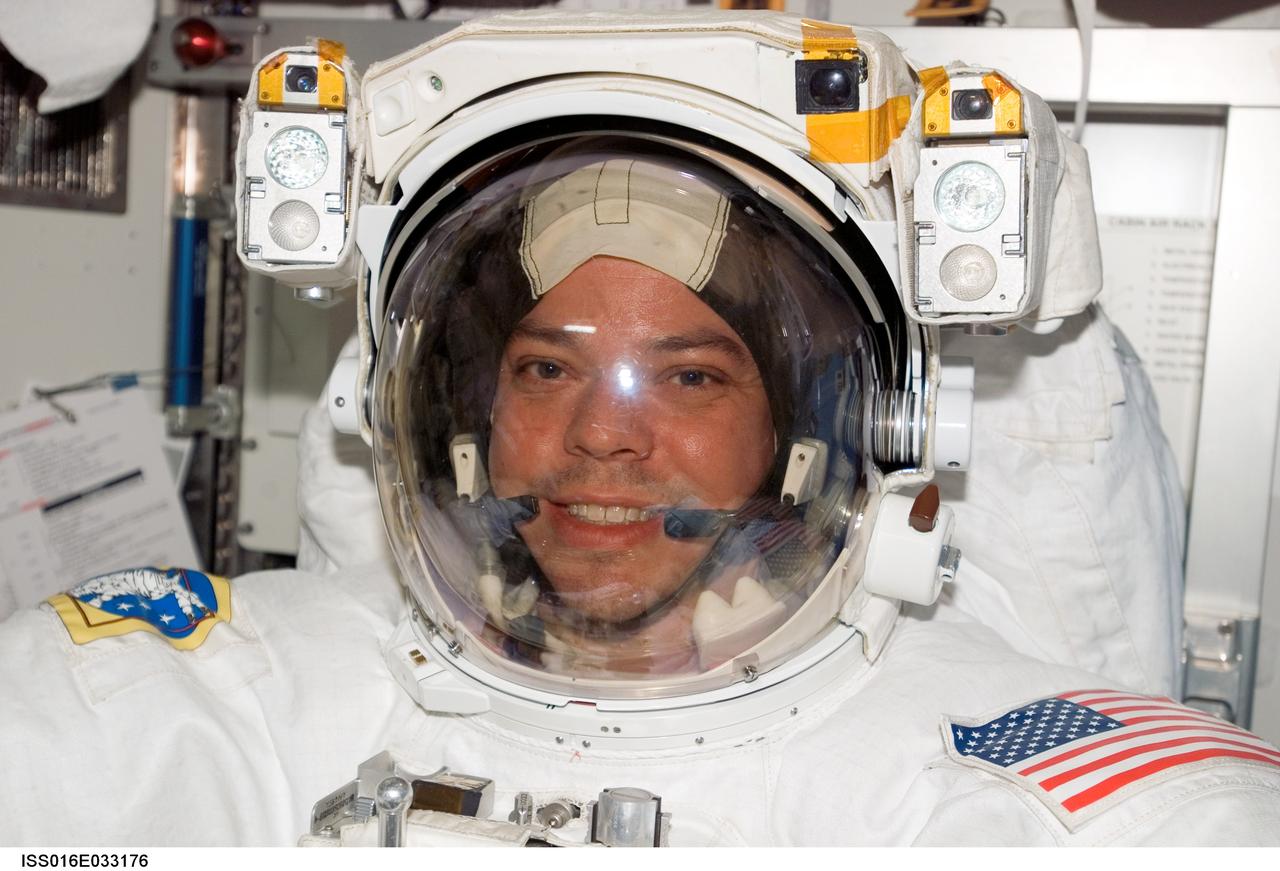 ISS016-E-033176 (20 March 2008) --- Attired in his Extravehicular Mobility Unit (EMU) spacesuit, astronaut Robert L. Behnken, STS-123 mission specialist, is pictured in the Quest Airlock of the International Space Station prior to the start of the mission's fourth scheduled session of extravehicular activity (EVA) while Space Shuttle Endeavour is docked with the station.