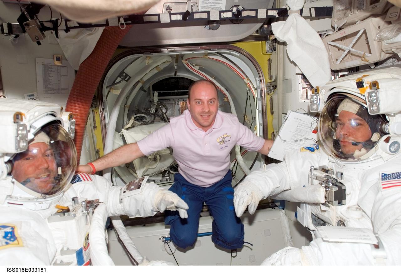 ISS016-E-033181 (20 March 2008) --- Attired in their Extravehicular Mobility Unit (EMU) spacesuits, astronauts Mike Foreman (left) and Robert L. Behnken, both STS-123 mission specialists; along with astronaut Garrett Reisman (center), Expedition 16 flight engineer, take a moment to pose for a photo as they prepare for the mission's fourth spacewalk in the Quest Airlock of the International Space Station while Space Shuttle Endeavour is docked with the station.
