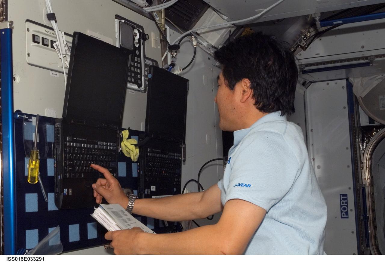ISS016-E-033291 (22 March 2008) --- Japan Aerospace Exploration Agency (JAXA) astronaut Takao Doi, STS-123 mission specialist, uses a computer in the Harmony node of the International Space Station while Space Shuttle Endeavour is docked with the station.