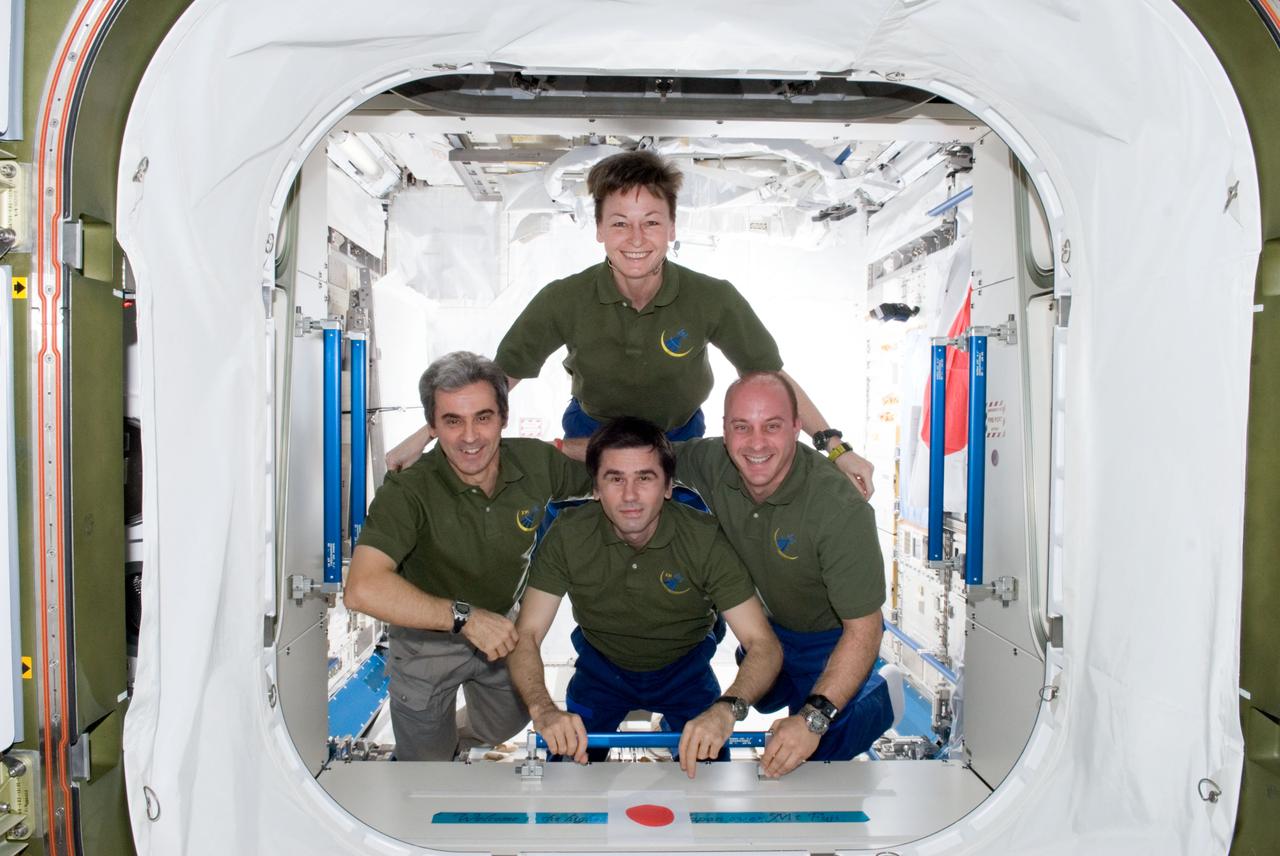 ISS016-E-033702 (24 March 2008) --- In addition to saying farewell to their brief Endeavour visitors, the Expedition 16 crewmembers spent part of the day posing for some in-space crew portraits in the Columbus laboratory onboard the International Space Station. Astronaut Peggy Whitson, commander, is joined by flight engineers (from the left) European Space Agency astronaut Leopold Eyharts (outgoing), Federal Space Agency cosmonaut Yuri Malenchenko and astronaut Garrett Reisman (incoming).