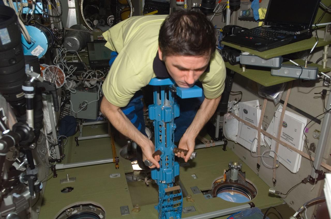 ISS016-E-033799 (27 March 2008) --- Russian Federal Space Agency cosmonaut Yuri Malenchenko, Expedition 16 flight engineer, uses a body mass measurement device (BMMD) in the Zvezda Service Module of the International Space Station.