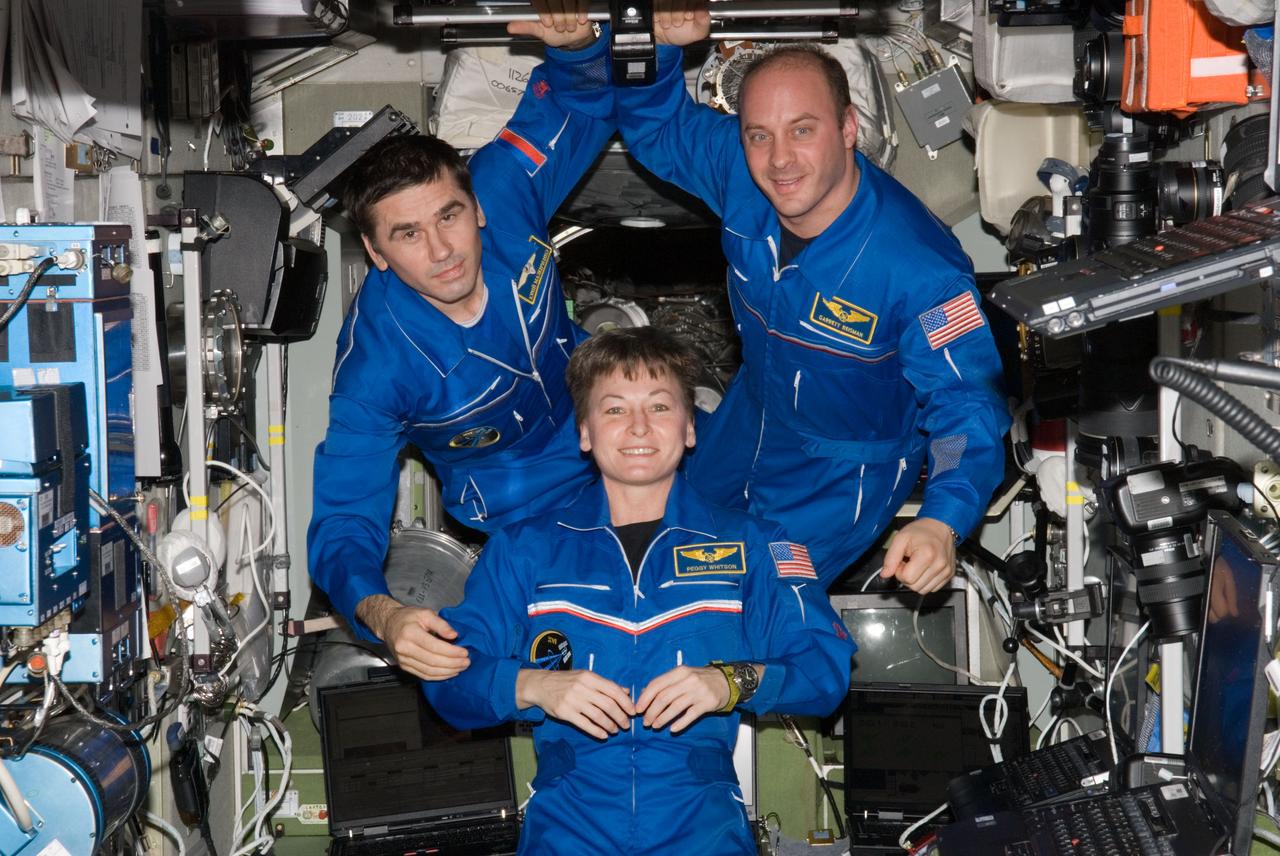 ISS016-E-034871 (8 April 2008) --- NASA astronauts Peggy Whitson, Expedition 16 commander; Garrett Reisman (right) and Russian Federal Space Agency cosmonaut Yuri Malenchenko, both flight engineers, pose for a photo in the Zvezda Service Module of the International Space Station.
