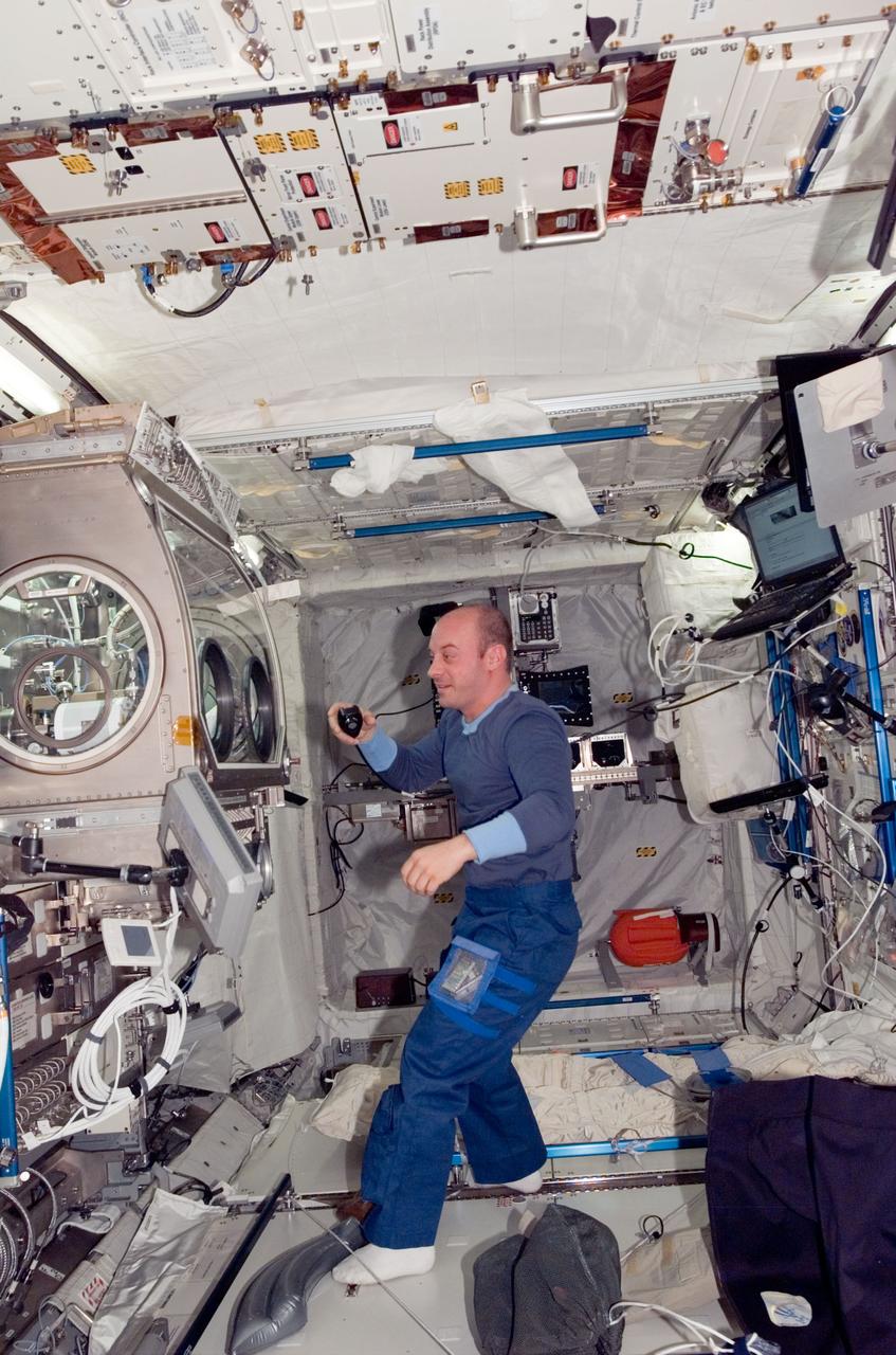 ISS016-E-036417 (14 April 2008) --- NASA astronaut Garrett Reisman, Expedition 16/17 flight engineer, is pictured near the Microgravity Science Glovebox (MSG) located in the Columbus laboratory of the International Space Station.