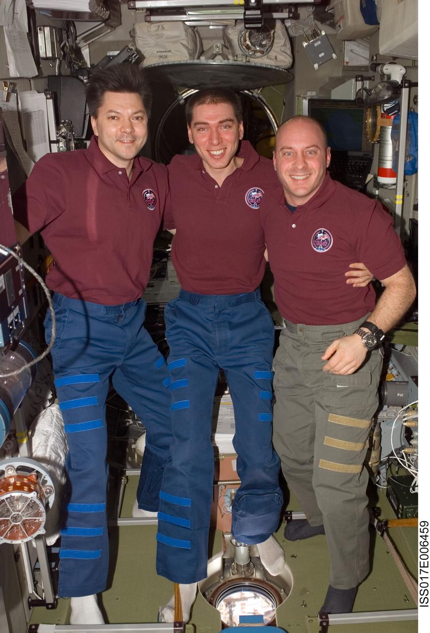 ISS017-E-006459 (8 May 2008) --- Cosmonauts Sergei Volkov (center), Expedition 17 commander; Oleg Kononenko (left) and NASA astronaut Garrett Reisman, both flight engineers, take a moment to pose for a photo in the Zvezda Service Module of the International Space Station.