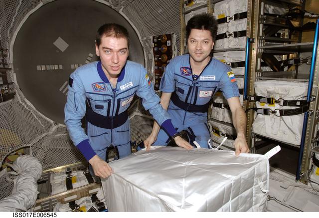 NASA image: Volkov and Kononenko with the stowage bags in the ATV during Expedition 17