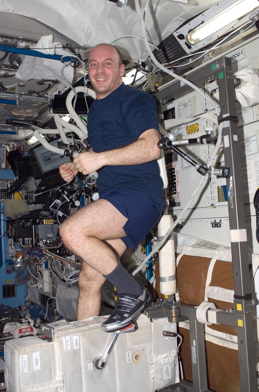 ISS017-E-006668 (11 May 2008) --- NASA astronaut Garrett Reisman, Expedition 17 flight engineer, exercises on the Cycle Ergometer with Vibration Isolation System (CEVIS) in the Destiny laboratory of the International Space Station.