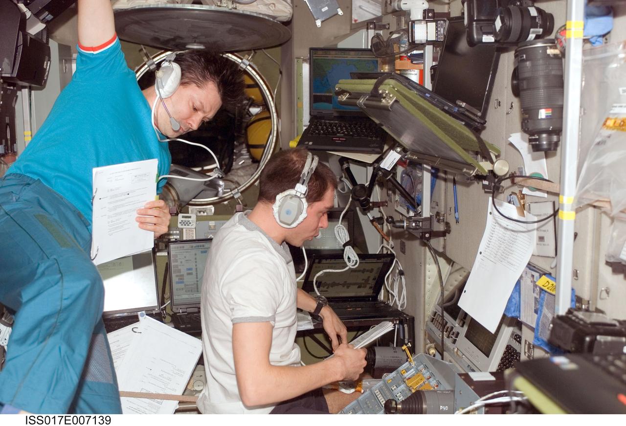 ISS017-E-007139 (16 May 2008) --- Cosmonauts Sergei Volkov (right) and Oleg Kononenko, Expedition 17 commander and flight engineer, respectively, monitor data at the manual TORU docking system controls in the Zvezda Service Module of the International Space Station during the docking of the Progress 29 supply vehicle. The Progress used the automated Kurs system to dock to the station's Zarya nadir port, which occurred at 4:39 p.m. (CDT) on May 16, 2008.
