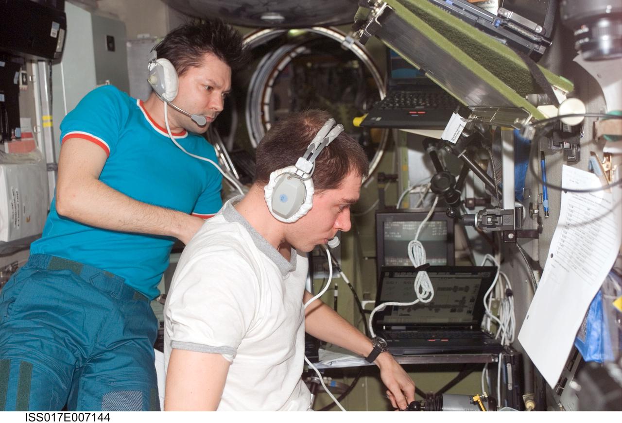 ISS017-E-007144 (16 May 2008) --- Cosmonauts Sergei Volkov (right) and Oleg Kononenko, Expedition 17 commander and flight engineer, respectively, monitor data at the manual TORU docking system controls in the Zvezda Service Module of the International Space Station during the docking of the Progress 29 supply vehicle. The Progress used the automated Kurs system to dock to the station's Zarya nadir port, which occurred at 4:39 p.m. (CDT) on May 16, 2008.