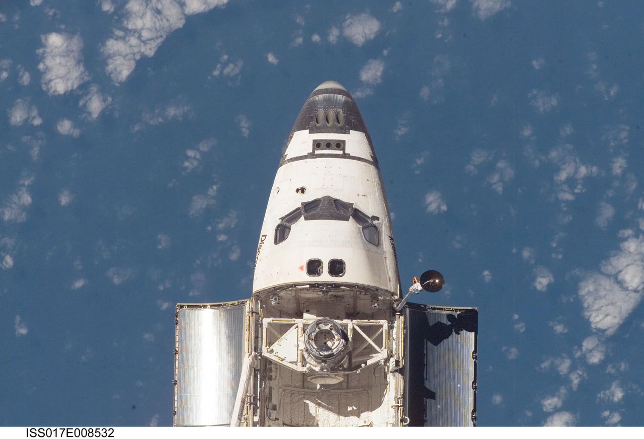 ISS017-E-008532 (2 June 2008) --- An overhead view of the exterior of Space Shuttle Discovery's crew cabin, part of its payload bay doors and docking system was provided by Expedition 17 crewmembers on the International Space Station (ISS). Before docking with the station, astronaut Mark Kelly, STS-124 commander, flew the shuttle through a roll pitch maneuver or basically a backflip to allow the space station crew a good view of Discovery's heat shield. Using digital still cameras equipped with both 400 and 800 millimeter lenses, the ISS crewmembers took a number of photos of the shuttle's thermal protection system and sent them down to teams on the ground for analysis. A 400 millimeter lens was used for this image.