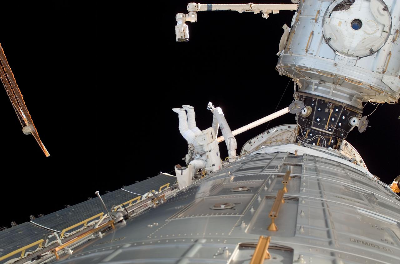 ISS017-E-008751 (3 June 2008) --- Astronaut Ron Garan, STS-124 mission specialist, participates in the mission's first scheduled session of extravehicular activity (EVA) as construction and maintenance continue on the International Space Station. During the six-hour, 48-minute spacewalk, Garan and astronaut Mike Fossum (out of frame), mission specialist, loosened restraints holding the Orbiter Boom Sensor System in its temporary stowage location on the space station's starboard truss, prepared the Kibo Japanese Pressurized Module (foreground) for its installation to the space station, demonstrated cleaning techniques for the Solar Alpha Rotary Joint's (SARJ) race ring, and installed a replacement SARJ Trundle Bearing Assembly.