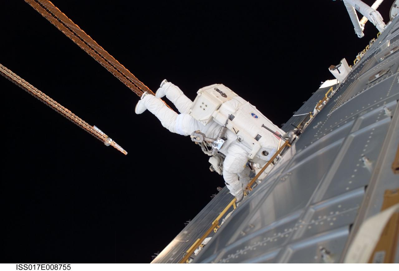ISS017-E-008755 (3 June 2008) --- Astronaut Ron Garan, STS-124 mission specialist, participates in the mission's first scheduled session of extravehicular activity (EVA) as construction and maintenance continue on the International Space Station. During the six-hour, 48-minute spacewalk, Garan and astronaut Mike Fossum (out of frame), mission specialist, loosened restraints holding the Orbiter Boom Sensor System in its temporary stowage location on the space station's starboard truss, prepared the Kibo Japanese Pressurized Module for its installation to the space station, demonstrated cleaning techniques for the Solar Alpha Rotary Joint's (SARJ) race ring, and installed a replacement SARJ Trundle Bearing Assembly.