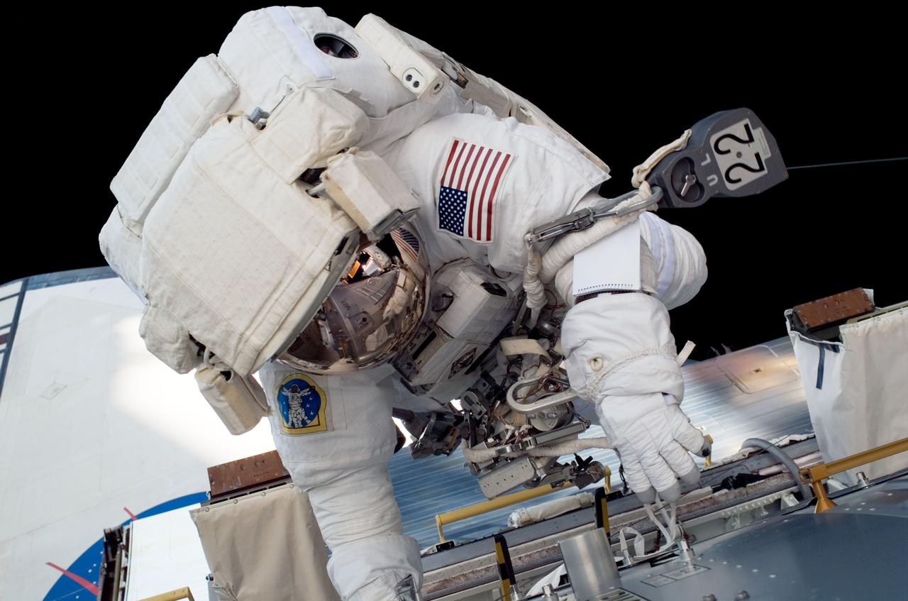 ISS017-E-008757 (3 June 2008) --- Astronaut Ron Garan, STS-124 mission specialist, participates in the mission's first scheduled session of extravehicular activity (EVA) as construction and maintenance continue on the International Space Station. During the six-hour, 48-minute spacewalk, Garan and astronaut Mike Fossum (out of frame), mission specialist, loosened restraints holding the Orbiter Boom Sensor System in its temporary stowage location on the space station's starboard truss, prepared the Kibo Japanese Pressurized Module for its installation to the space station, demonstrated cleaning techniques for the Solar Alpha Rotary Joint's (SARJ) race ring, and installed a replacement SARJ Trundle Bearing Assembly.