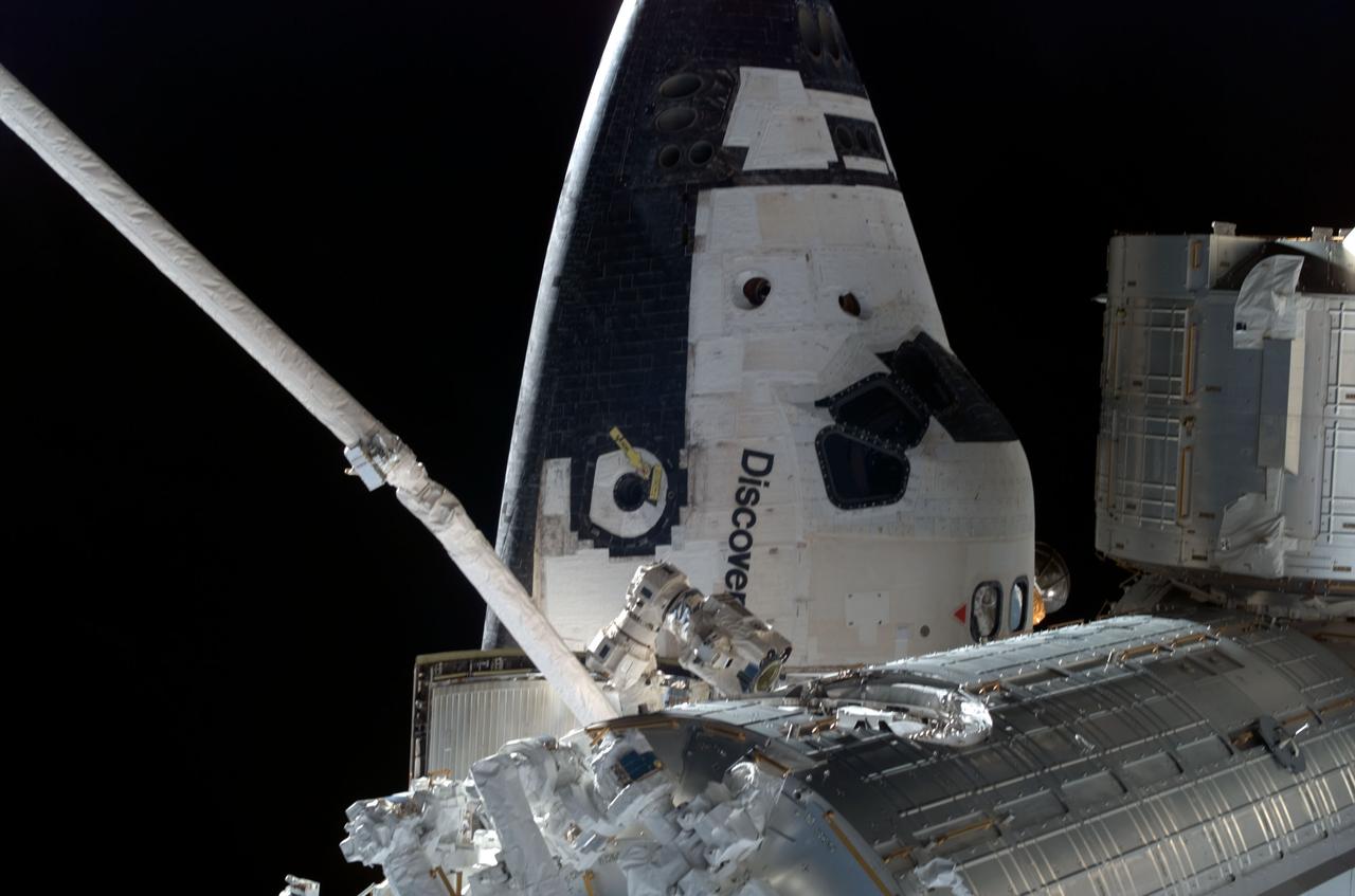 ISS017-E-009038 (5 June 2008) --- Backdropped by the blackness of space, the forward section of Space Shuttle Discovery, while docked to the International Space Station, and partial views of the Japanese Pressurized Module (bottom) and the Japanese Logistics Module are featured in this image photographed by a crewmember during the STS-124 mission's second planned spacewalk.