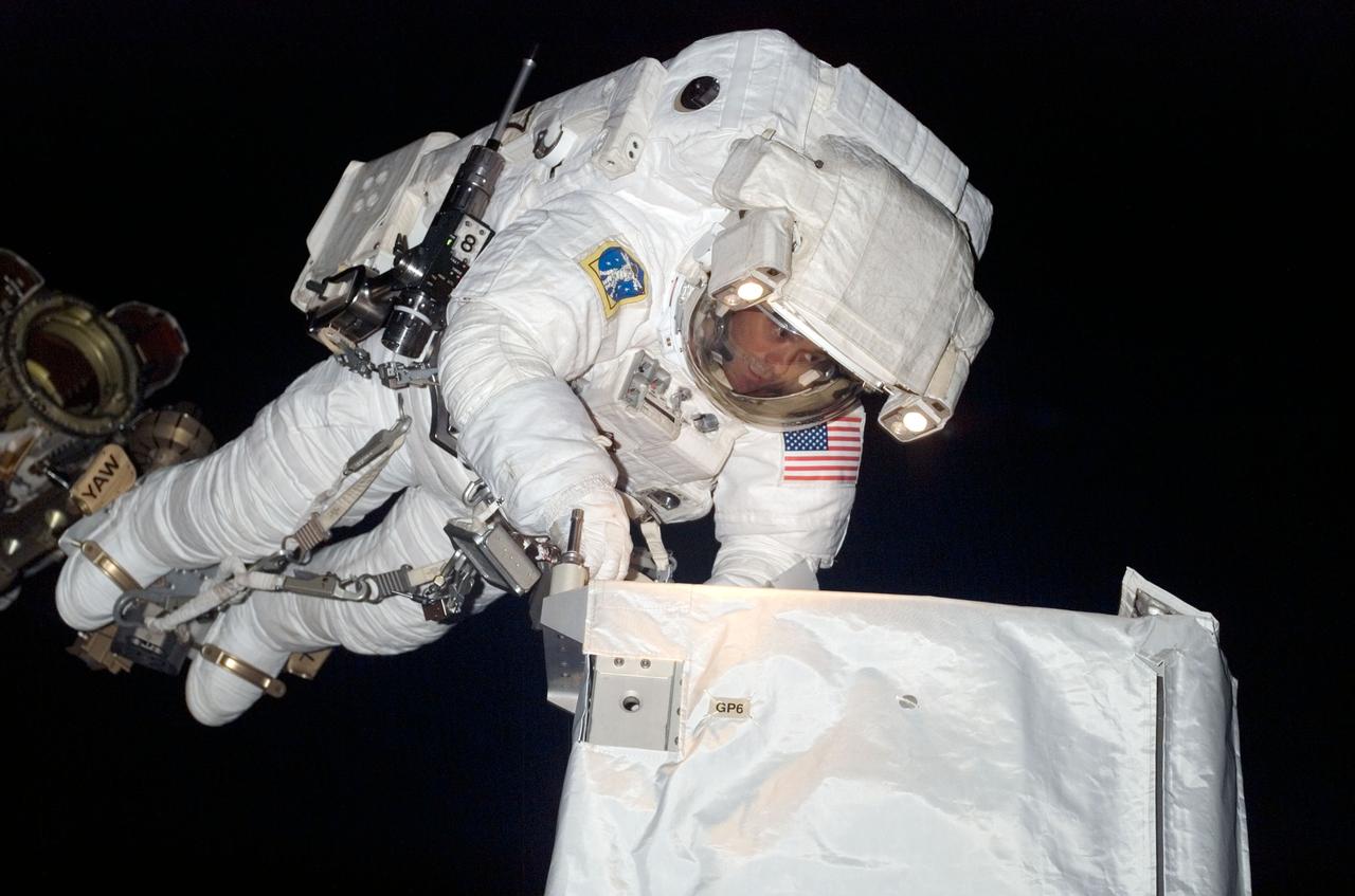 ISS017-E-009220 (8 June 2008) --- Anchored to a Canadarm2 mobile foot restraint, astronaut Ron Garan, STS-124 mission specialist, participates in the mission's third scheduled session of extravehicular activity (EVA) as construction and maintenance continue on the International Space Station. During the six-hour, 33-minute spacewalk, Garan and astronaut Mike Fossum (out of frame), mission specialist, exchanged a depleted Nitrogen Tank Assembly for a new one, removed thermal covers and launch locks from the Kibo laboratory, reinstalled a repaired television camera onto the space station's left P1 truss, and retrieved samples of a dust-like substance from the left Solar Alpha Rotary Joint for analysis by experts on the ground.