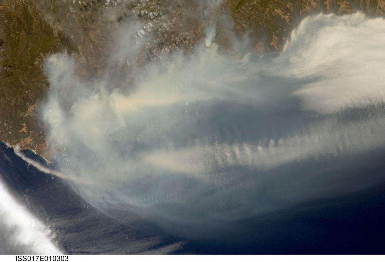 ISS017-E-010303 (4 July 2008) --- The Basin fire in central California is featured in this image photographed by astronaut Greg Chamitoff, Expedition 17 flight engineer, on the International Space Station. One of the largest and most destructive fires raging across California over the July 4 weekend was the Basin fire, threatening Big Sur, and covering the coast in a thick blanket of smoke. Chamitoff, observing the fires from approximately 344 kilometers above Earth (215 miles), was able to capture the regional view of the smoke pall. At the time this image was taken, more than 300 fires were burning in California alone. This Basin fire was triggered by a thunderstorm, has burned 77,000 acres, and is still only partially contained.