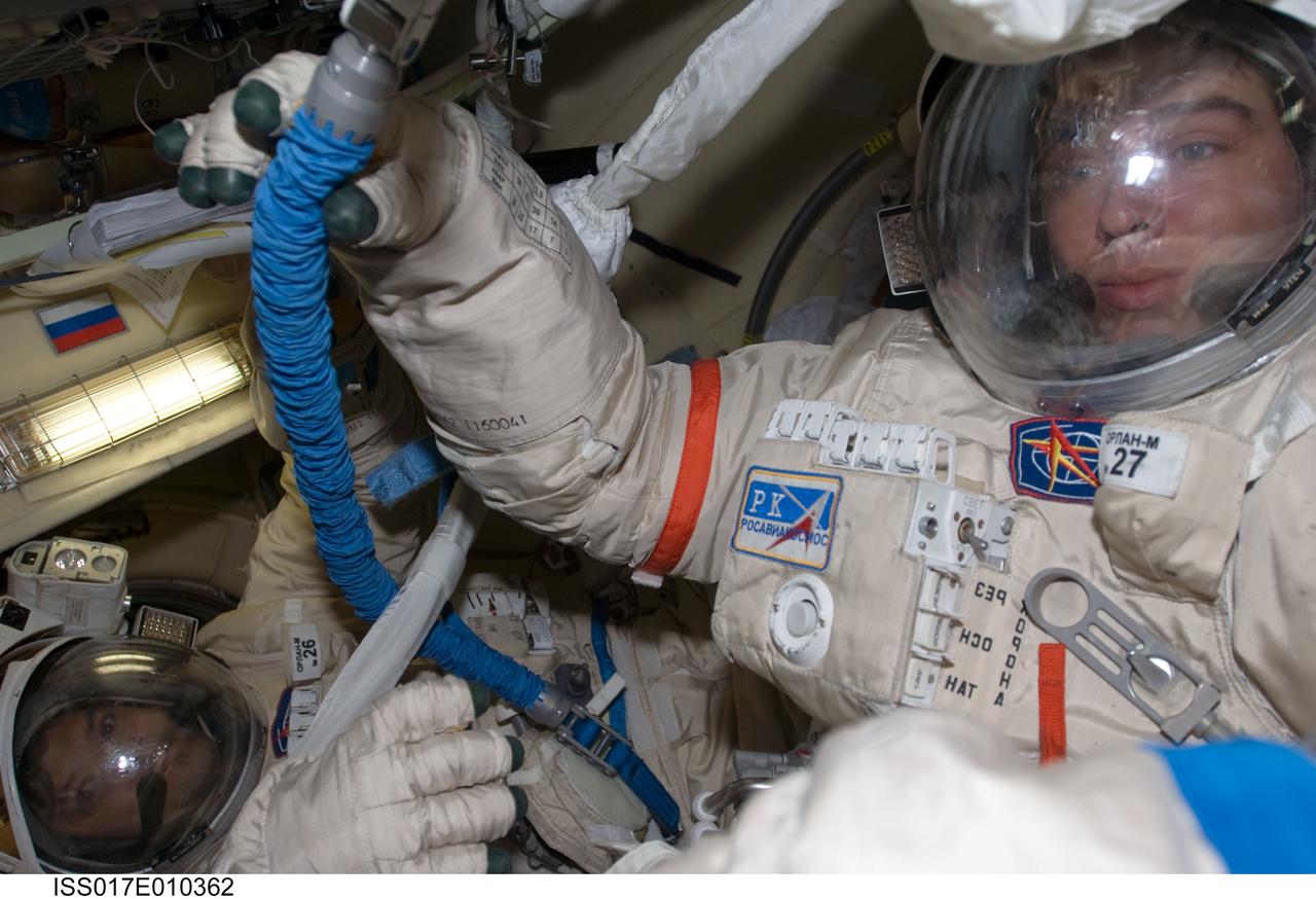 ISS017-E-010362 (8 July 2008) --- Attired in their Russian Orlan spacesuits, Russian Federal Space Agency cosmonauts Sergei Volkov (right) and Oleg Kononenko, Expedition 17 commander and flight engineer, respectively, prepare for their spacewalk scheduled for July 10. During the full dress rehearsal "dry run", the crewmembers tested translation capability and the status of the suits' communications gear and other systems while in the Pirs Docking Compartment of the International Space Station.