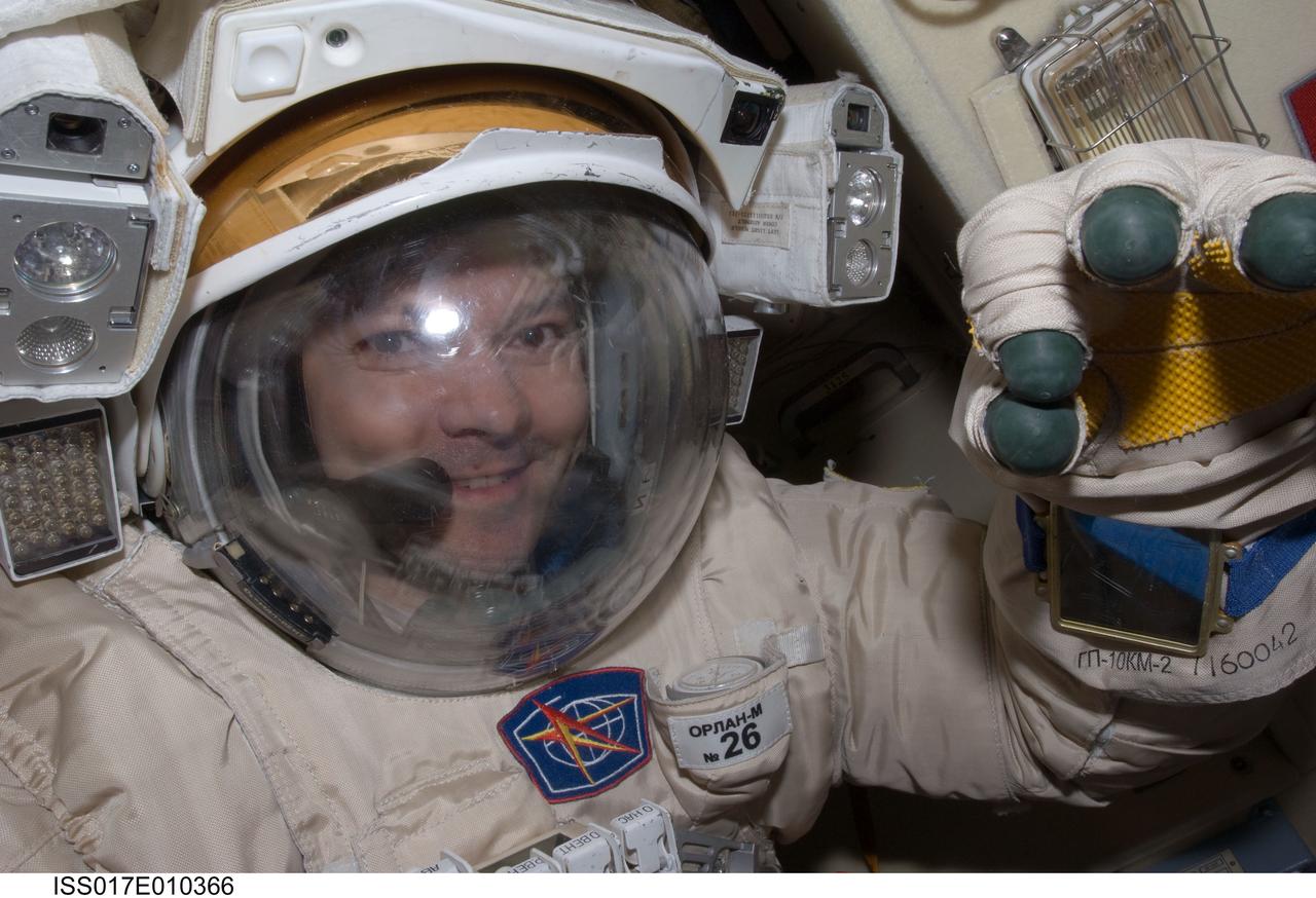 ISS017-E-010366 (8 July 2008) --- Attired in his Russian Orlan spacesuit, Russian Federal Space Agency cosmonaut Oleg Kononenko, Expedition 17 flight engineer, prepares for the spacewalk scheduled for July 10. During the full dress rehearsal "dry run", Kononenko and cosmonaut Sergei Volkov (out of frame), commander, tested translation capability and the status of the suits' communications gear and other systems while in the Pirs Docking Compartment of the International Space Station.