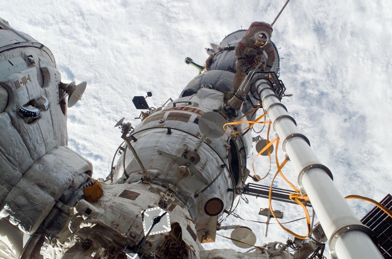 ISS017-E-011097 (15 July 2008) --- Russian Federal Space Agency cosmonaut Sergei Volkov, Expedition 17 commander, participates in a session of extravehicular activity (EVA) as construction and maintenance continue on the International Space Station. During the five-hour, 54-minute spacewalk, Volkov and cosmonaut Oleg Kononenko (out of frame), flight engineer, continued to outfit the station's exterior, including the installation of a docking target on the Zvezda Service Module.