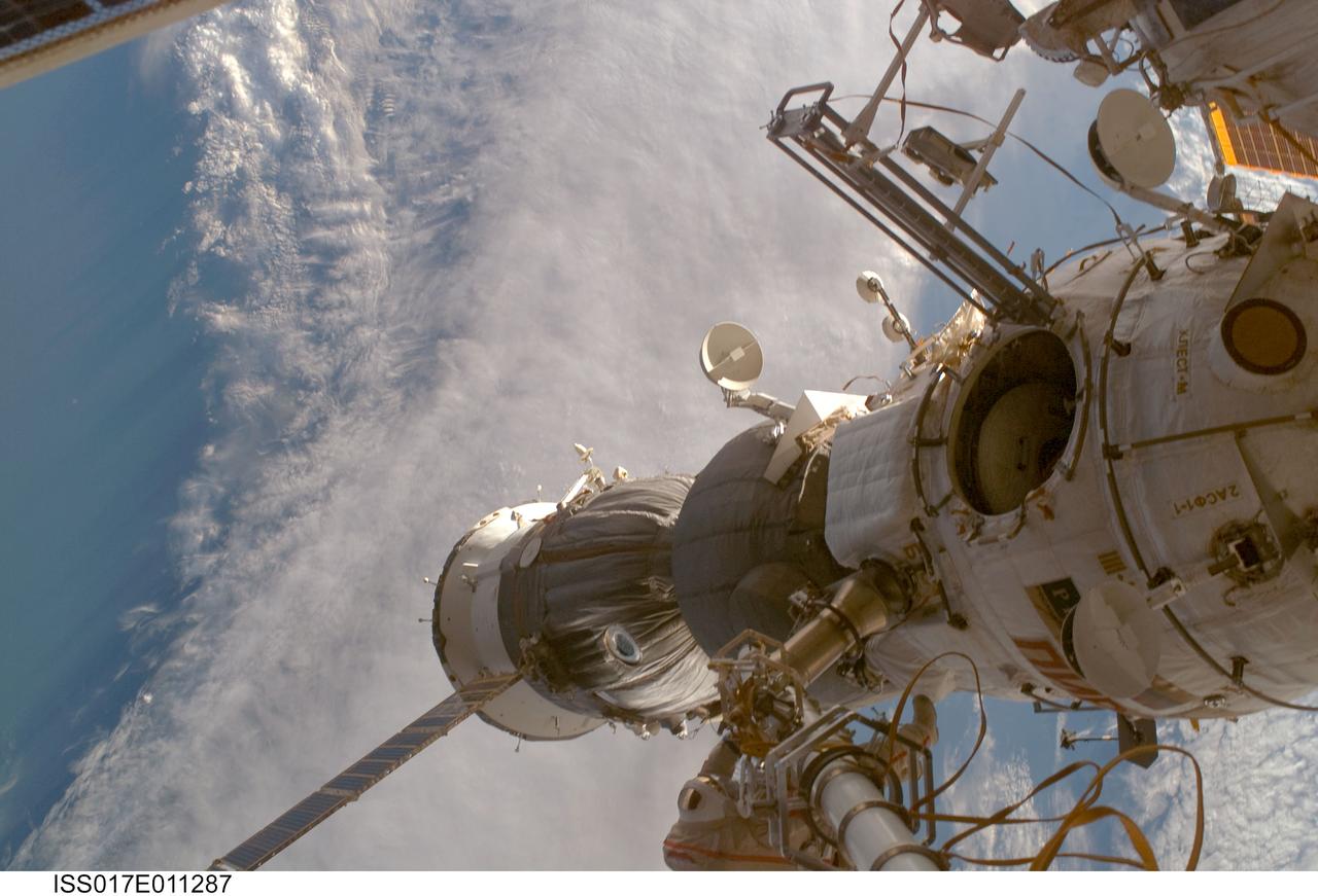 ISS017-E-011287 (15 July 2008) --- Russian Federal Space Agency cosmonaut Sergei Volkov (bottom center), Expedition 17 commander, participates in a session of extravehicular activity (EVA) as construction and maintenance continue on the International Space Station. During the five-hour, 54-minute spacewalk, Volkov and cosmonaut Oleg Kononenko (out of frame), flight engineer, continued to outfit the station's exterior, including the installation of a docking target on the Zvezda Service Module.