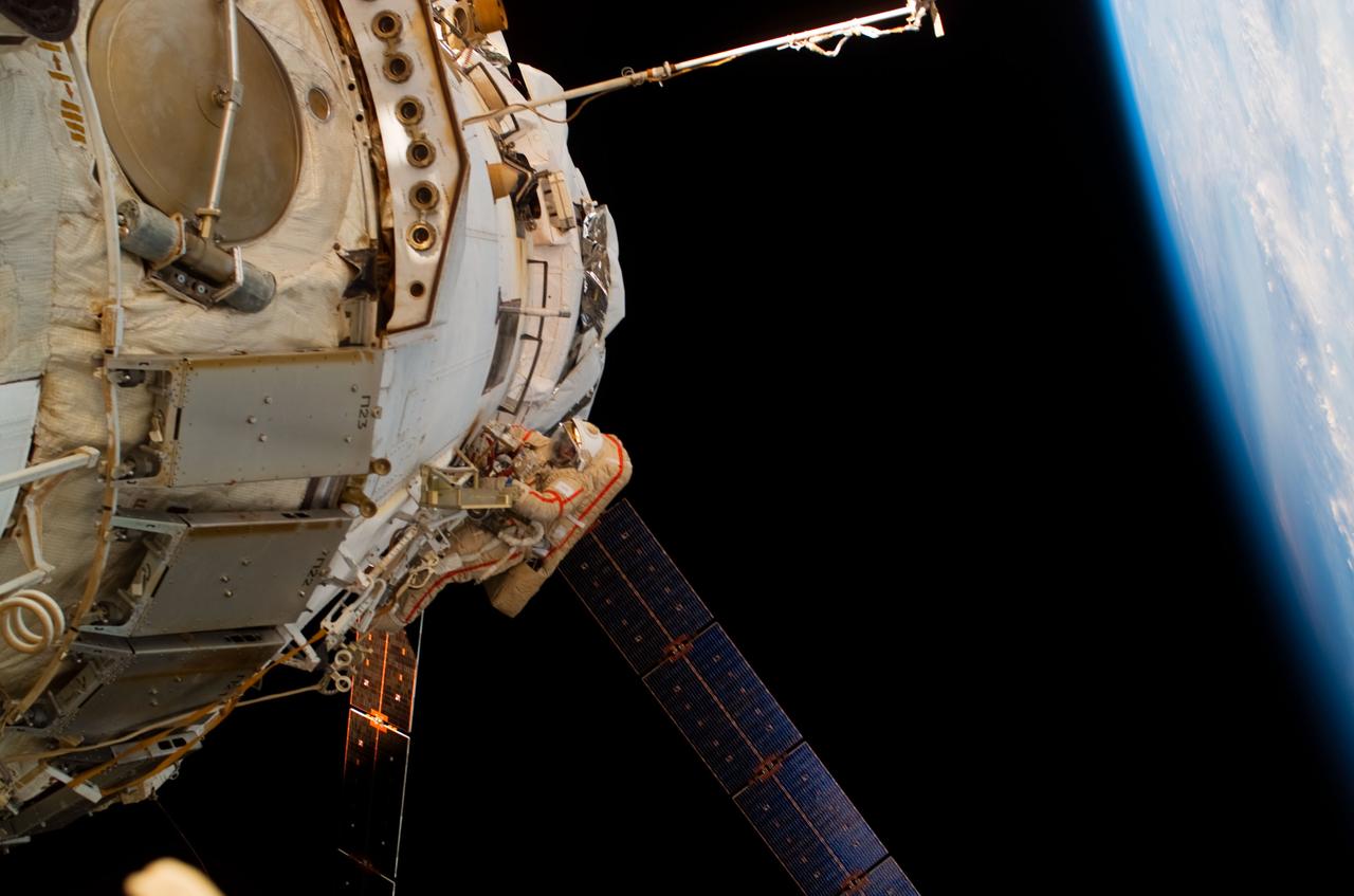 ISS017-E-011315 (15 July 2008) --- Russian Federal Space Agency cosmonaut Sergei Volkov, Expedition 17 commander, participates in a session of extravehicular activity (EVA) as construction and maintenance continue on the International Space Station. During the five-hour, 54-minute spacewalk, Volkov and cosmonaut Oleg Kononenko (out of frame), flight engineer, continued to outfit the station's exterior, including the installation of a docking target on the Zvezda Service Module.