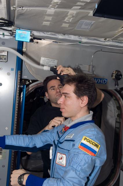 NASA image: Chamitoff gives Volkov a haircut in the Node 2 during Expedition 17