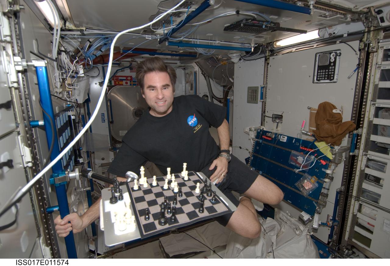 ISS017-E-011574 (19 July 2008) --- NASA astronaut Greg Chamitoff, Expedition 17 flight engineer, smiles for a photo near a chess board in the Harmony node of the International Space Station.