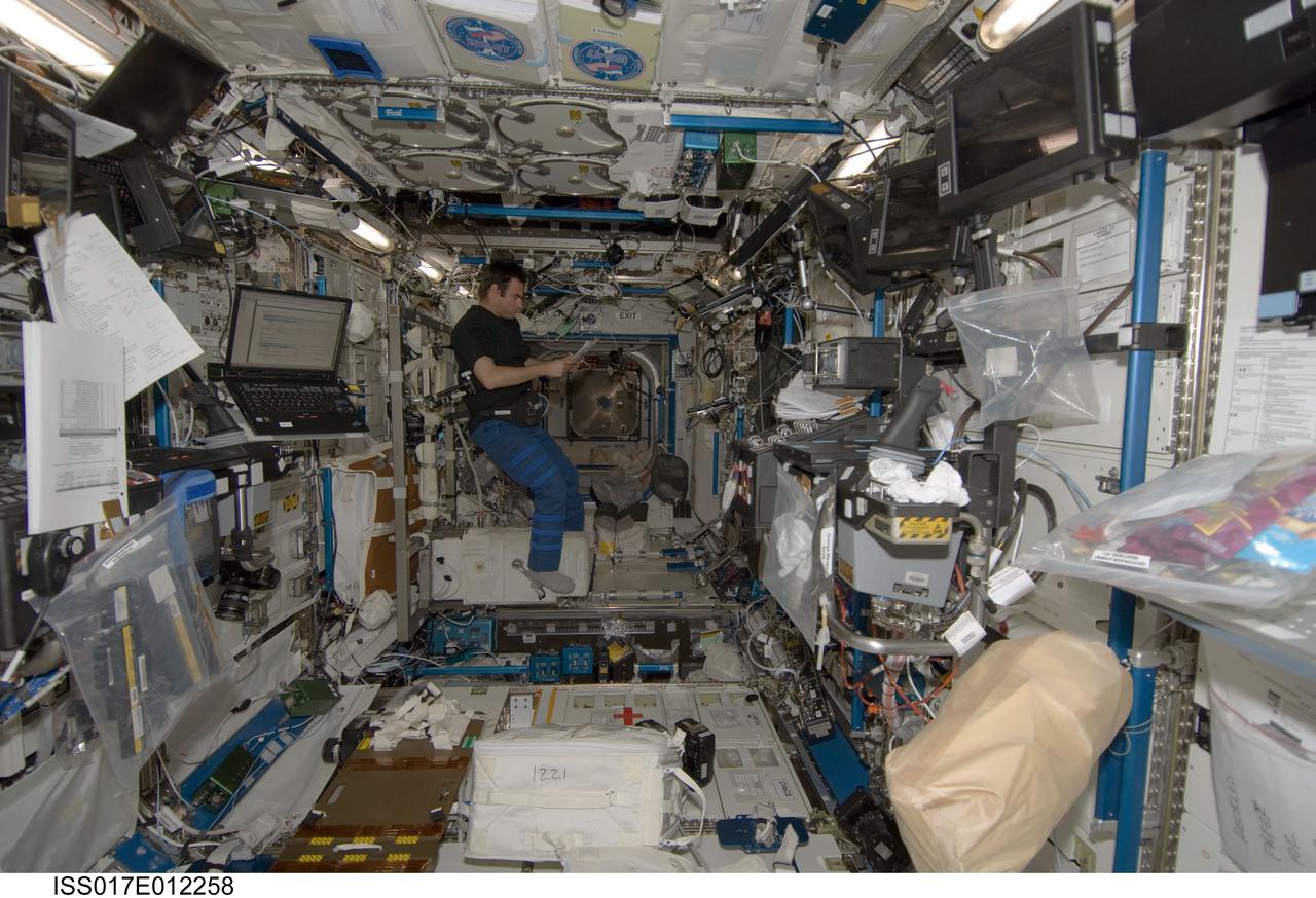 ISS017-E-012258 (16 July 2008) --- NASA astronaut Greg Chamitoff, Expedition 17 flight engineer, looks over a checklist in the Destiny laboratory of the International Space Station.