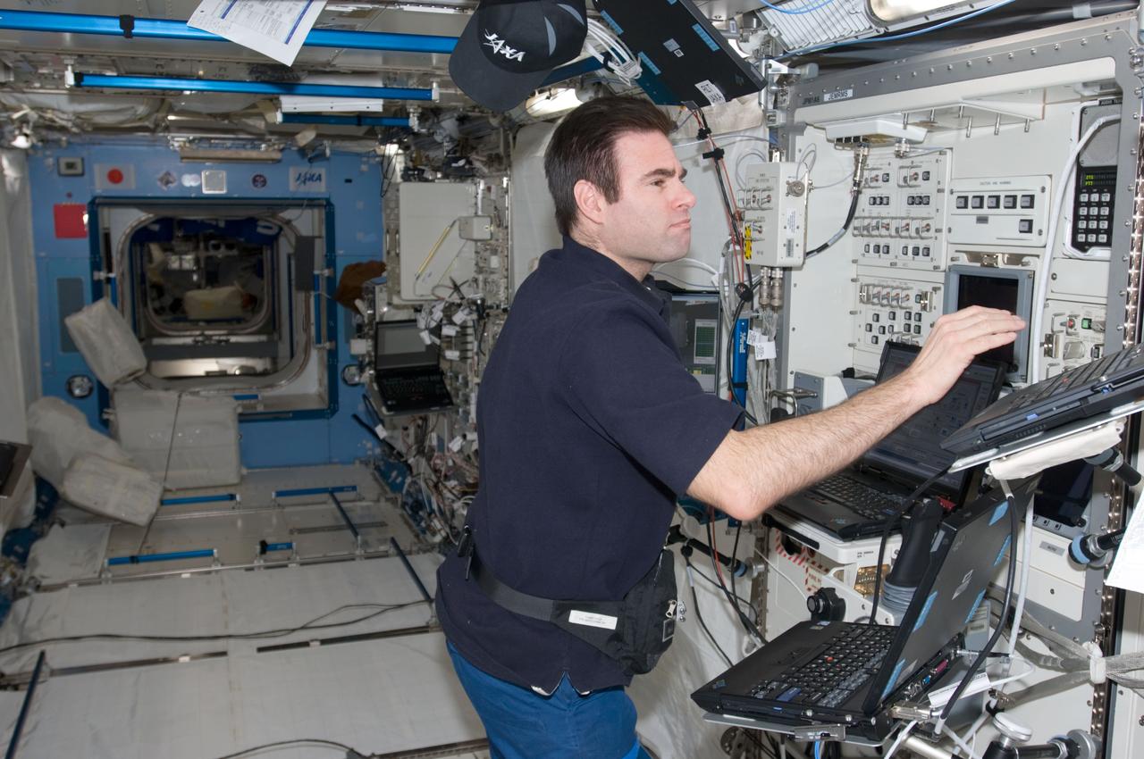 ISS017-E-013970 (22 Aug. 2008) --- Astronaut Greg Chamitoff,  Expedition 17 flight engineer, conducts a  function checkout for the Japanese Experiment Module's Remote Manipulator System in the Kibo laboratory on the International Space Station.