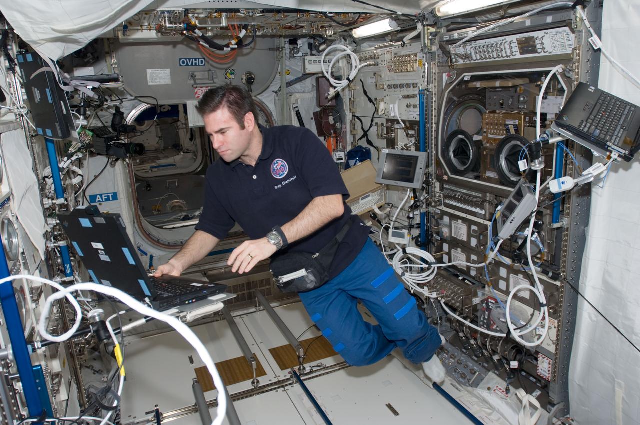 ISS017-E-014001 (23 Aug. 2008) --- Astronaut Greg Chamitoff,  Expedition 17 flight engineer, works with the Microgravity Sciences Glovebox and the Commercial Generic Bioprocessing Apparatus in the Columbus laboratory on the International Space Station.