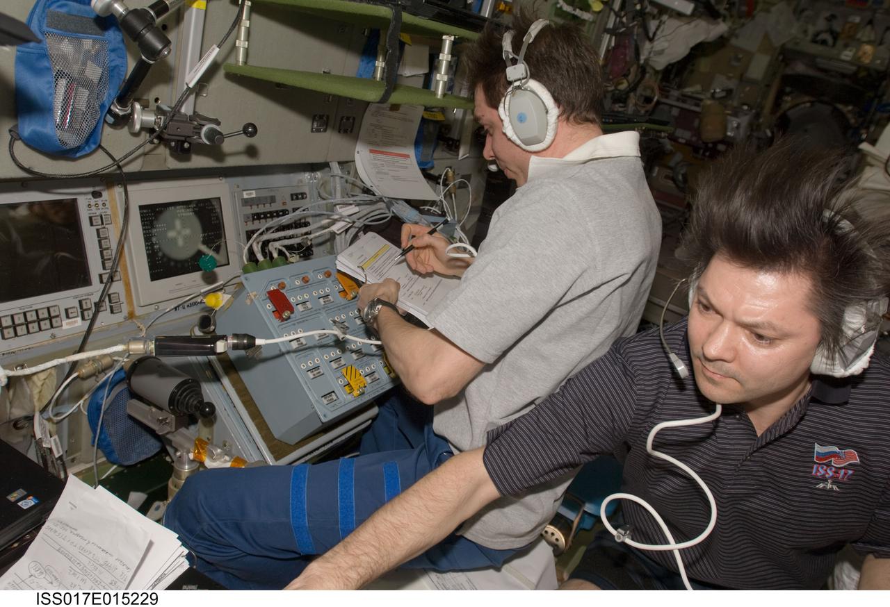 ISS017-E-015229 (5 Sept. 2008) --- Russian Federal Space Agency cosmonauts Sergei Volkov (left) and Oleg Kononenko, Expedition 17 commander and flight engineer, respectively, make preparations in the International Space Station's Zvezda Service Module for the undocking of the European Space Agency's (ESA) "Jules Verne" Automated Transfer Vehicle (ATV). The ATV departed from the aft port of Zvezda at 4:29 p.m. (CDT) on Sept. 5, 2008 and was placed in a parking orbit for three weeks, scheduled to be deorbited on Sept. 29 when lighting conditions are correct for an ESA imagery experiment of reentry.