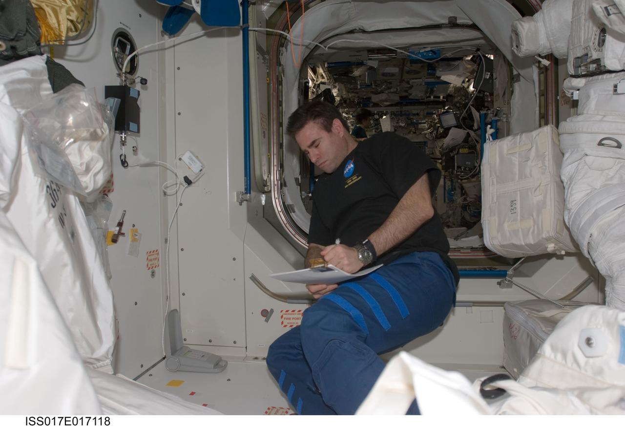 ISS017-E-017118 (20 Sept. 2008) --- Astronaut Greg Chamitoff, Expedition 17 flight engineer, looks over procedures checklists in the Unity node of the International Space Station.