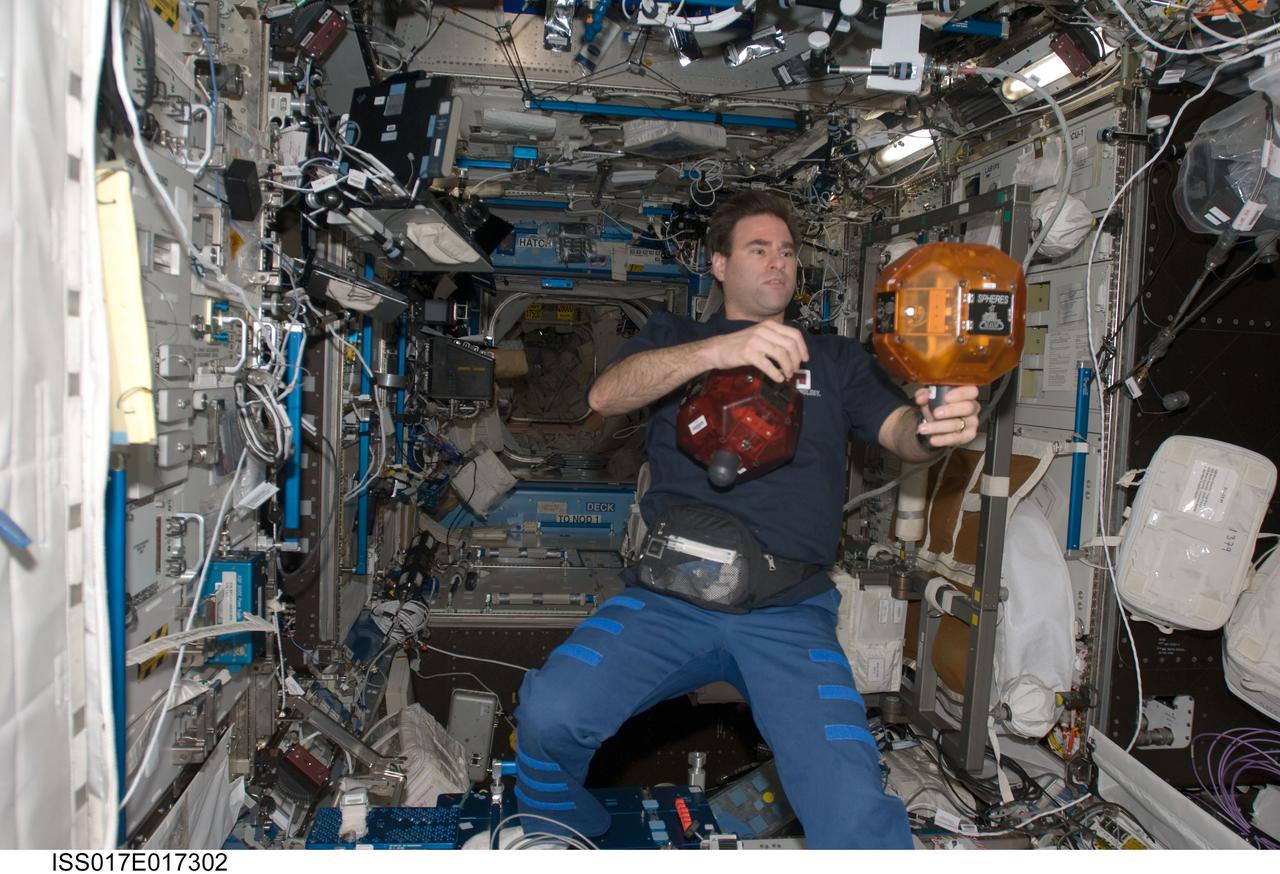 ISS017-E-017302 (27 Sept. 2008) --- Astronaut Greg Chamitoff, Expedition 17 flight engineer, works with the Synchronized Position Hold, Engage, Reorient, Experimental Satellites (SPHERES) in the Destiny laboratory of the International Space Station.