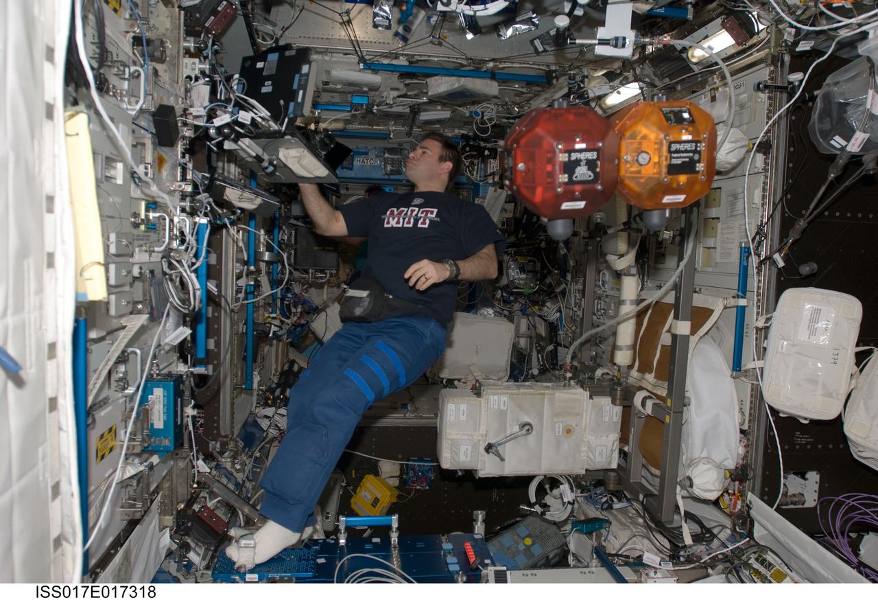 ISS017-E-017318 (27 Sept. 2008) --- Astronaut Greg Chamitoff, Expedition 17 flight engineer, uses a computer while working with the Synchronized Position Hold, Engage, Reorient, Experimental Satellites (SPHERES) in the Destiny laboratory of the International Space Station.